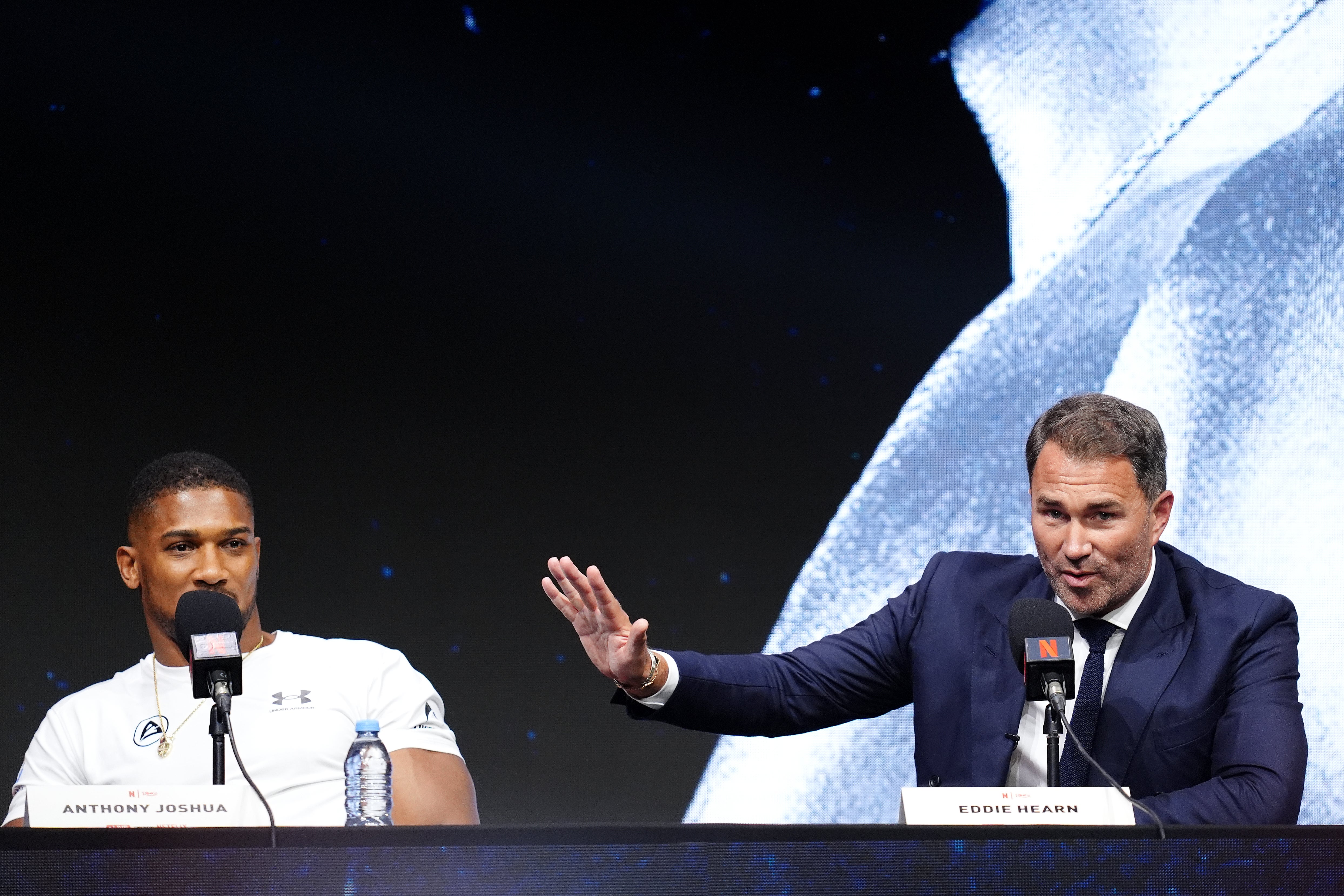 Eddie Hearn (right) says Anthony Joshua is taking an eight-figure difference to have the fight in London (PA)