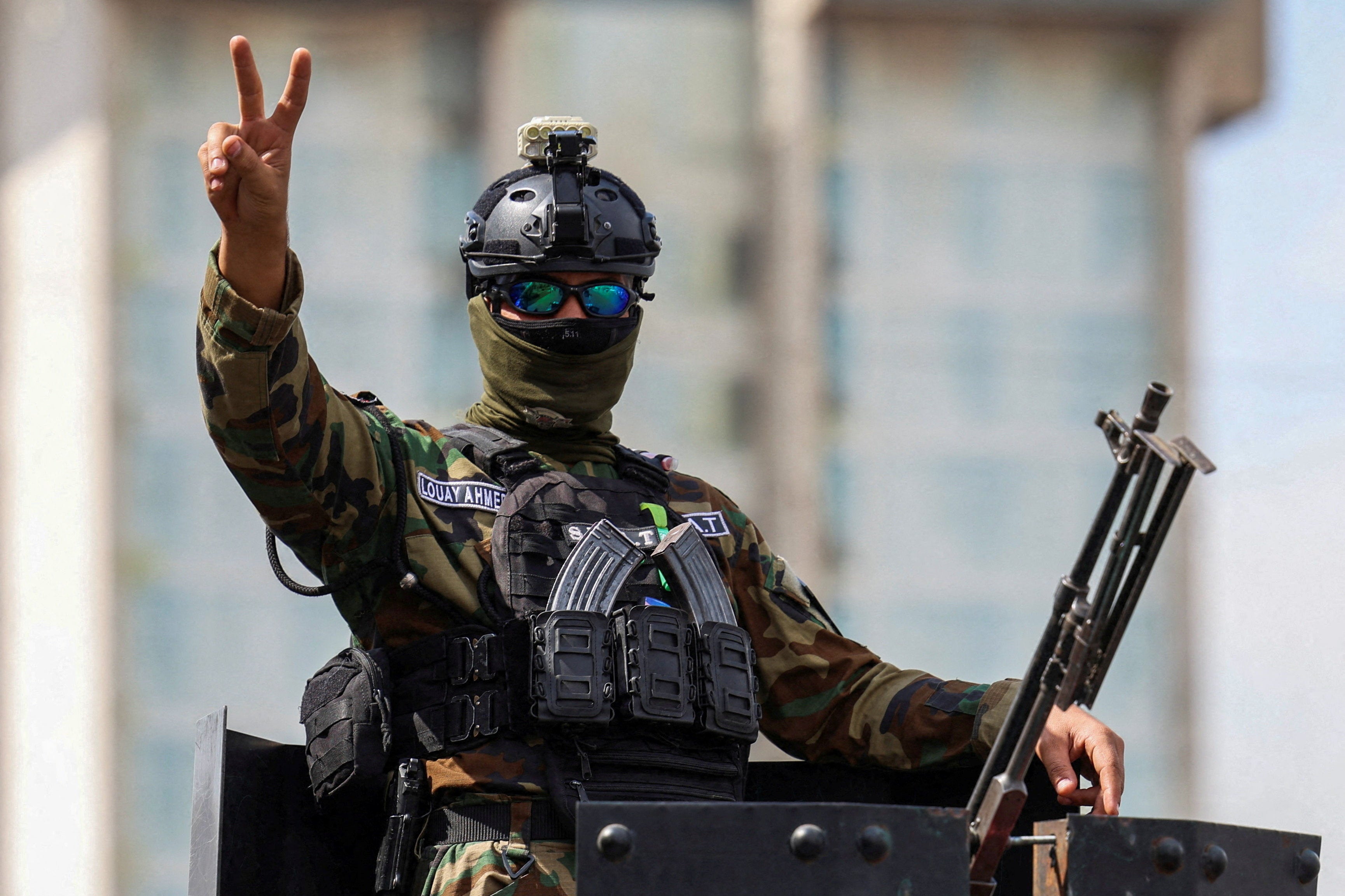 A member of the Iraqi security forces gestures after the last U.S. troops left an air base in northern Iraq under a deal between Baghdad and Washington