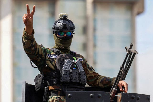 A member of the Iraqi security forces gestures after the last U.S. troops left an air base in northern Iraq under a deal between Baghdad and Washington