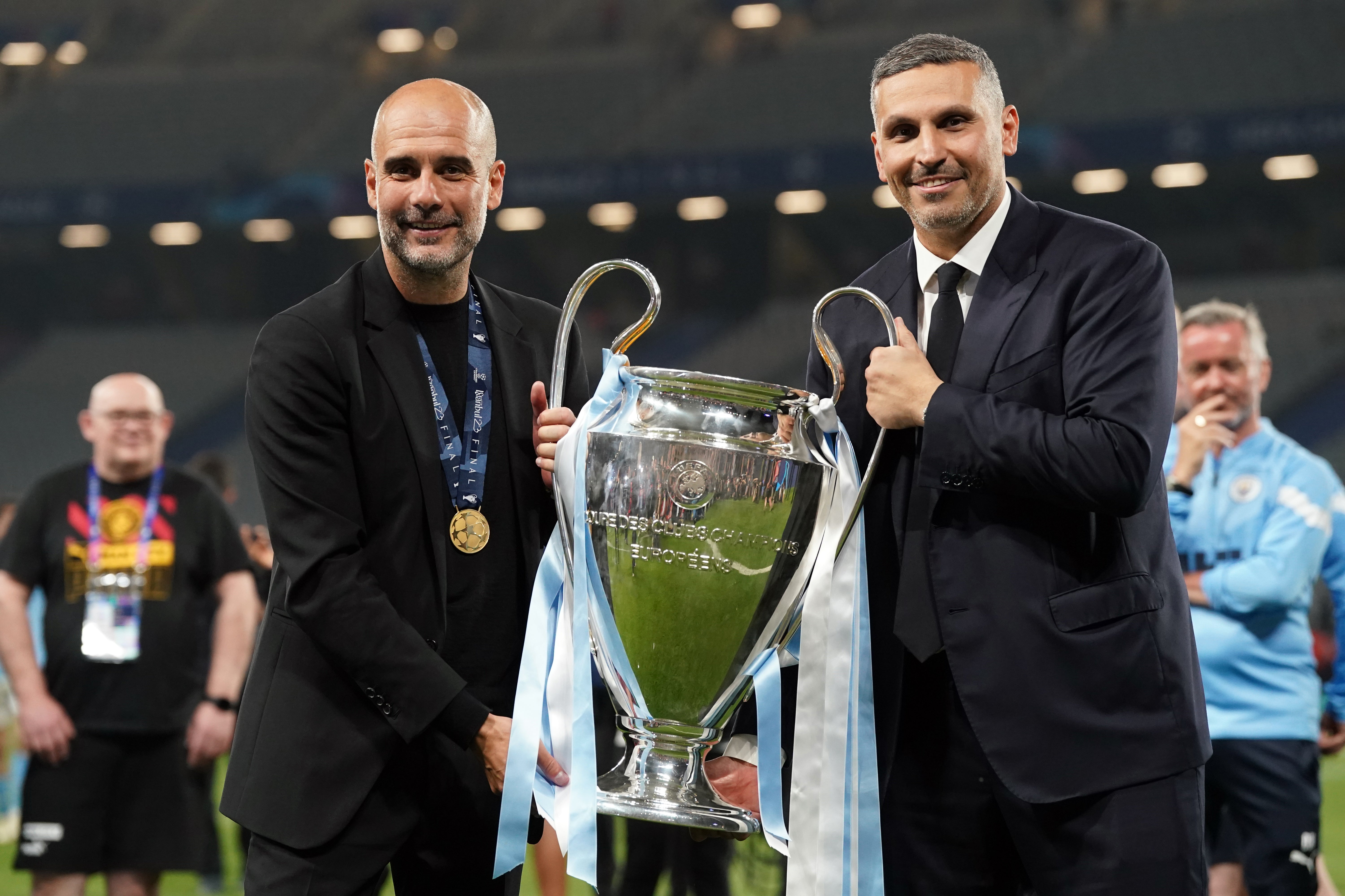 Manchester City chairman Khaldoon Al Mubarak, right, with the Champions League trophy (PA)