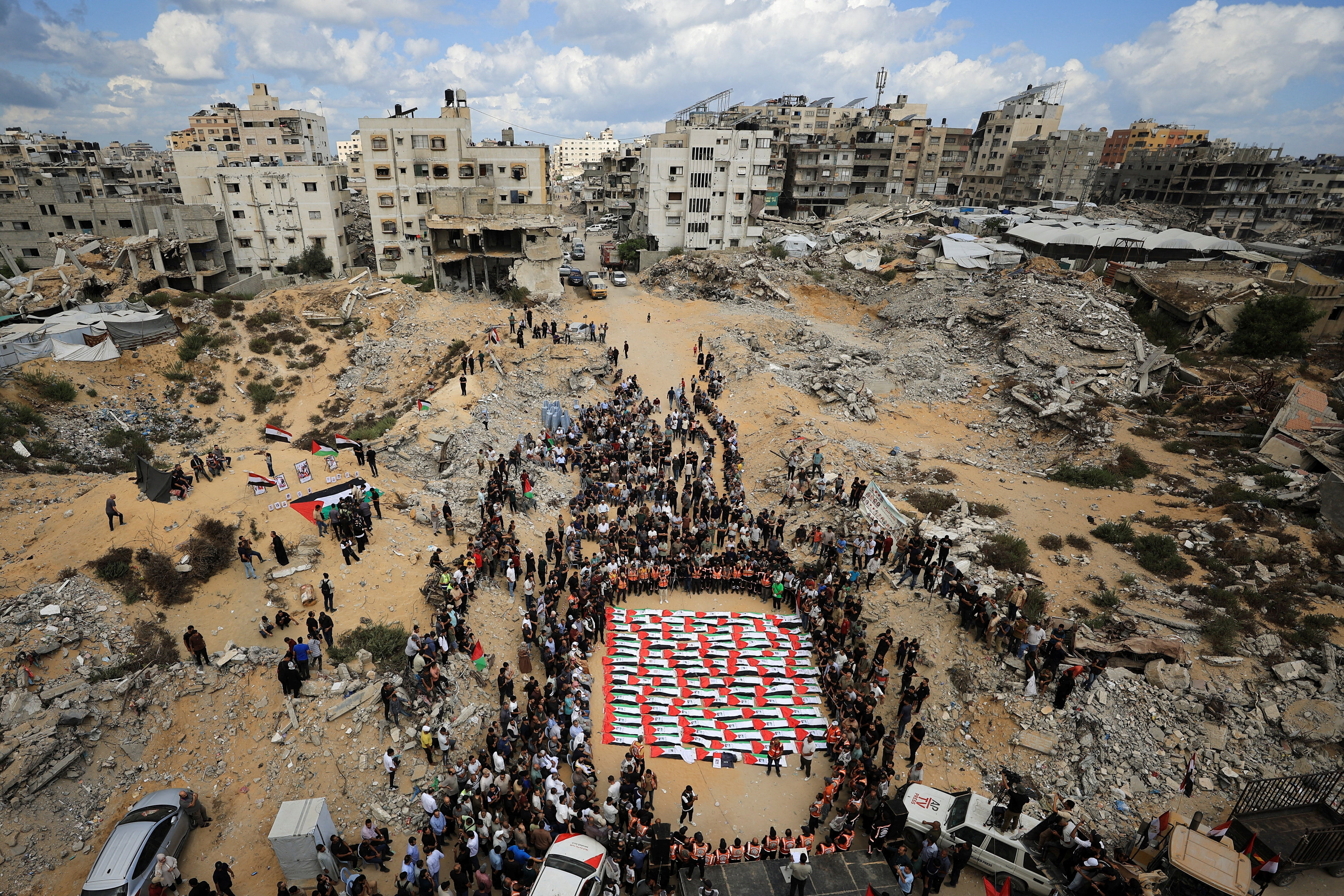 Mourners attend a mass funeral for Palestinians whose bodies were recovered from the rubble of a residential building hit in an Israeli strike in October 2023, according to the Civil Defence, in Gaza City October 1