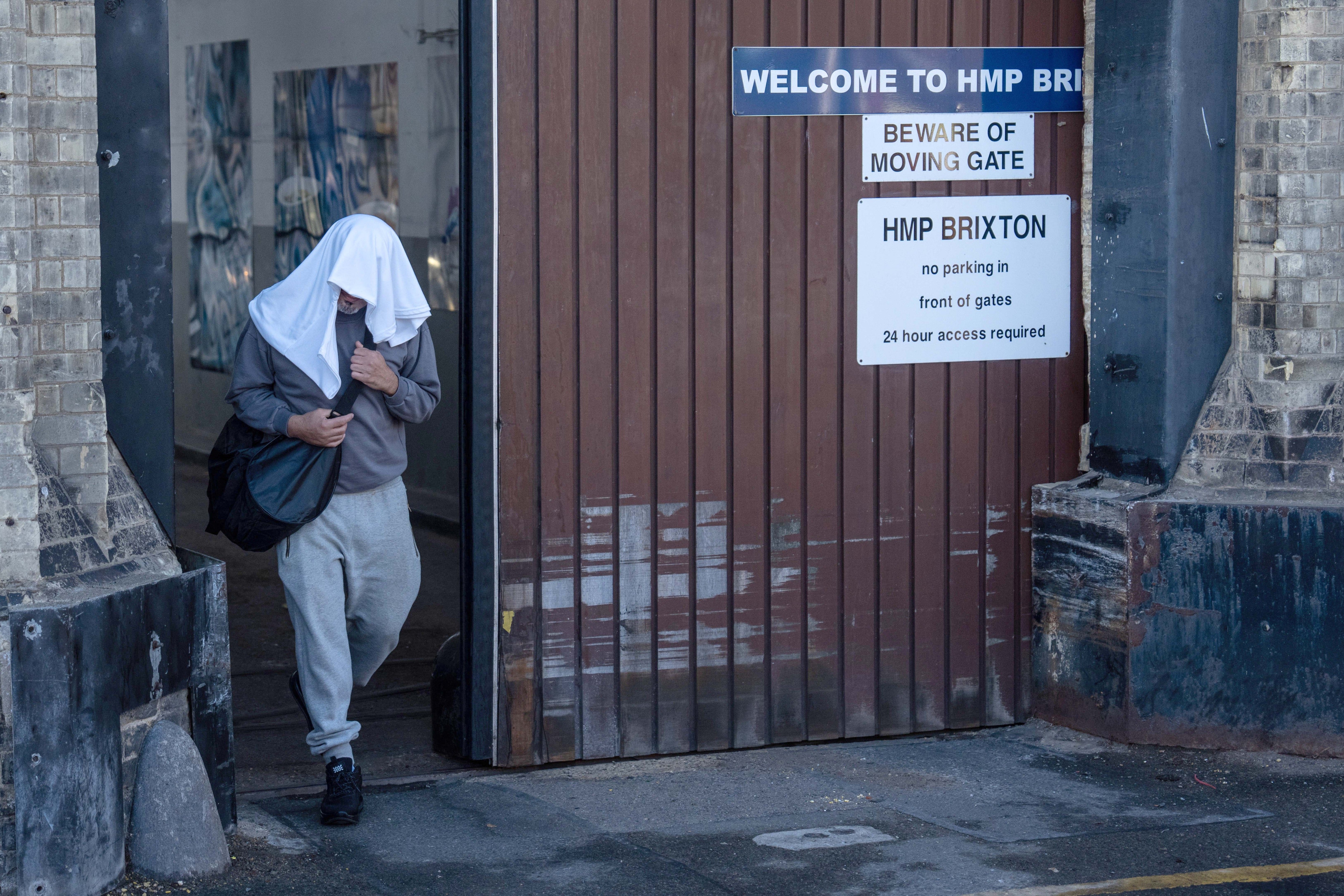 An inmate walks from HMP Brixton on early release