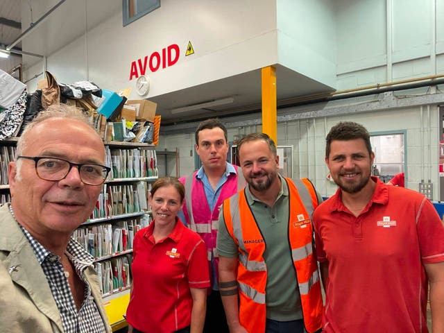 Stroud MP Simon Opher (left) spoke to Royal Mail staff in Dursley in July on the delays. He said the local postmen and women were working hard in the circumstances