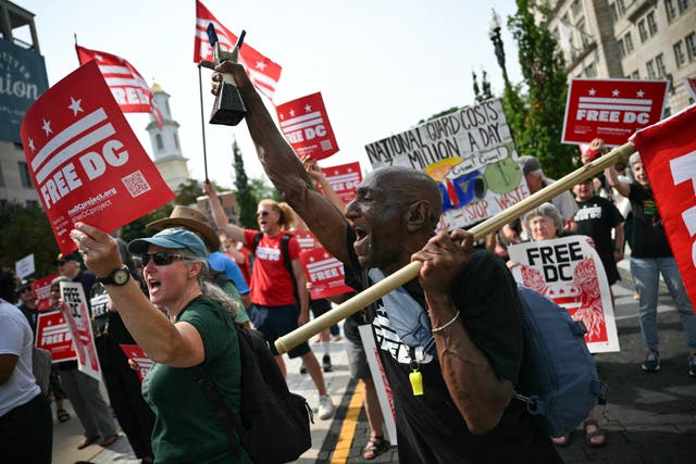 Demonstrators rally during a 'FreeDC' protest in Washington, DC, on August 11 to mark one year since President Trump deployed members of the National Guard into the city