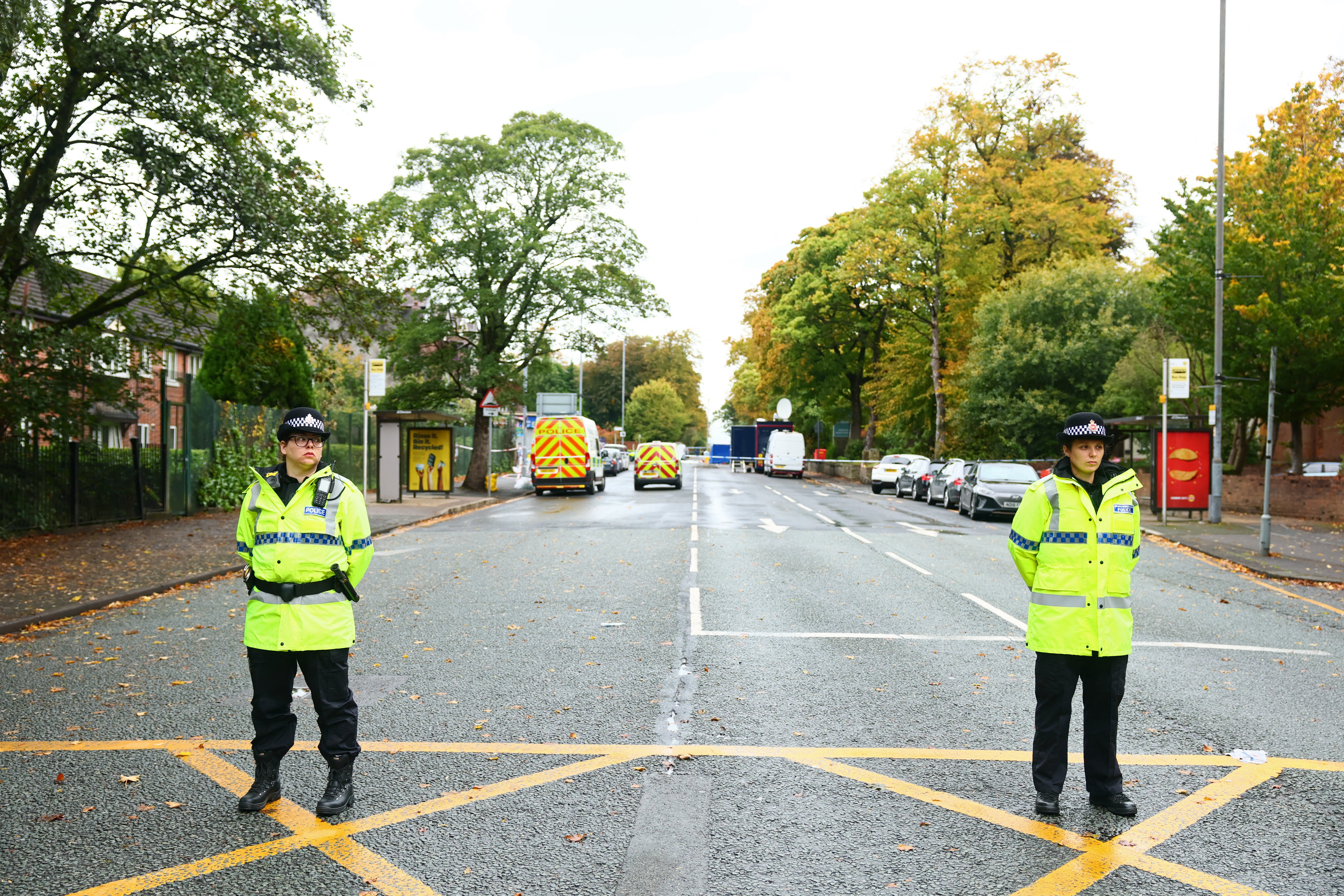 Police officers stand by a cordon on the main road outside Heaton Park Hebrew Congregation synagogue in Crumpsall, north Manchester, on October 3, 2025, following an attack at the synagogue