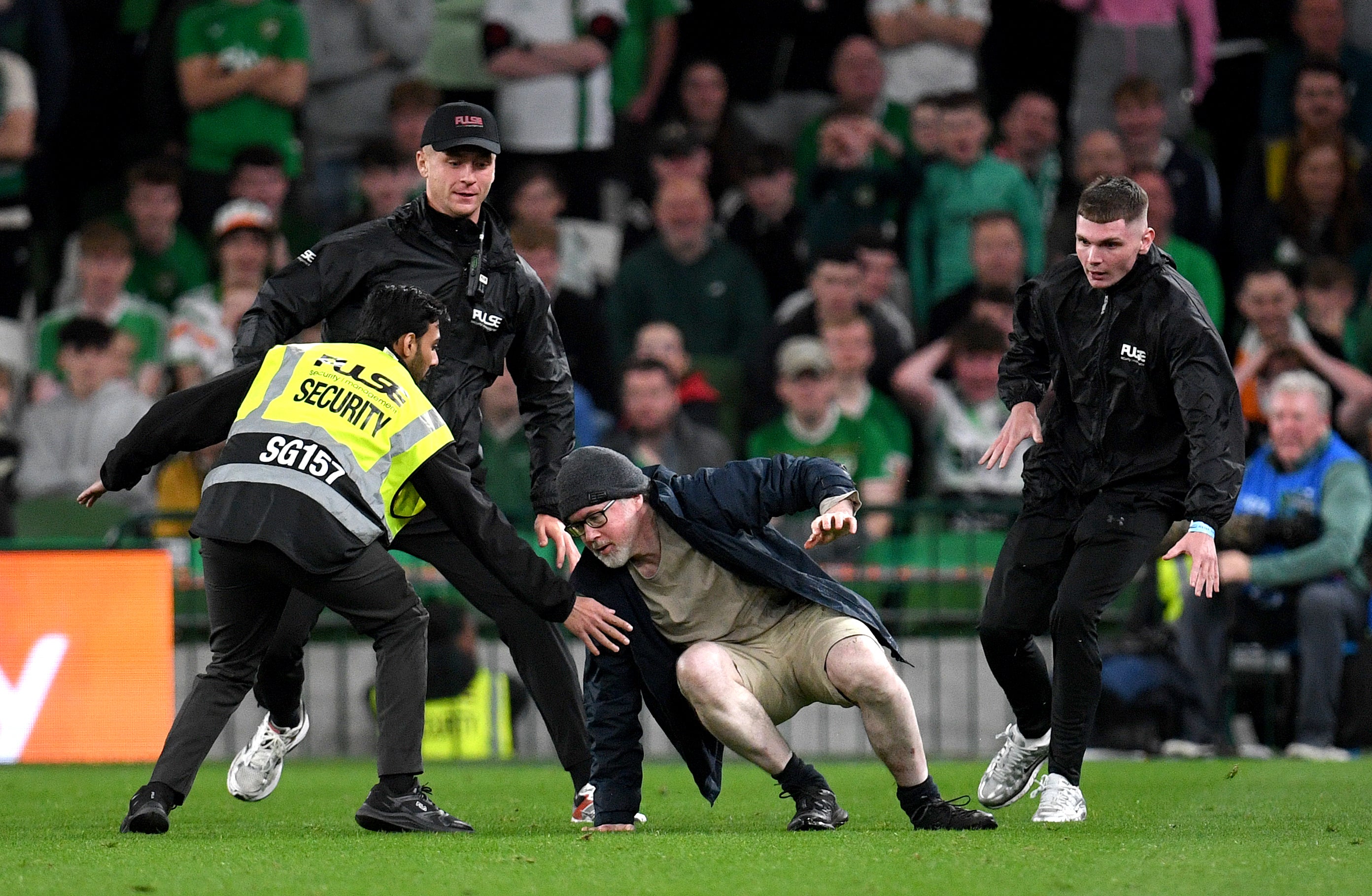 A protesting pitch invader was tackled and removed by security (Getty)