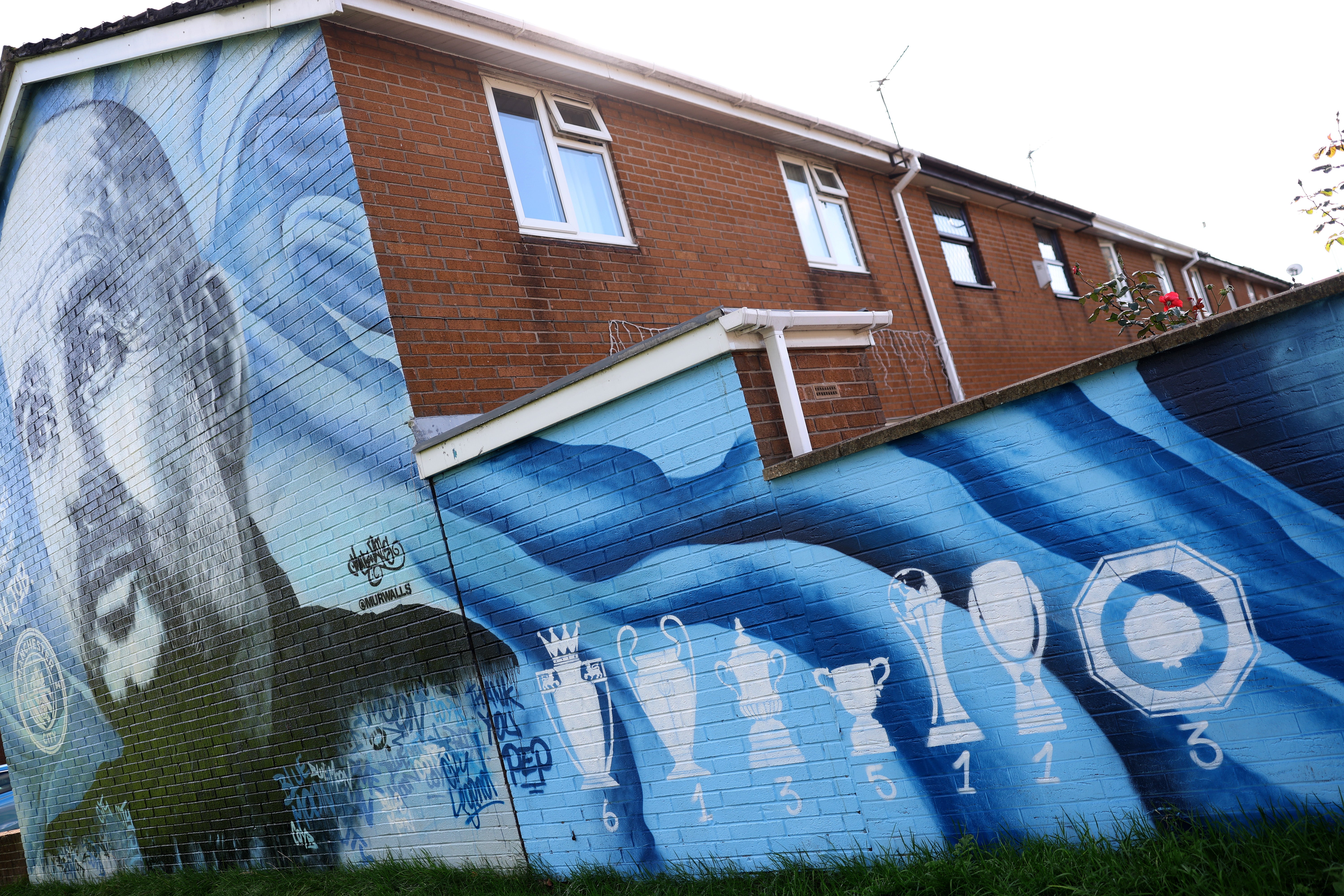 A mural of Pep Guardiola and the trophies that he won during his time at the Etihad Stadium (Getty)