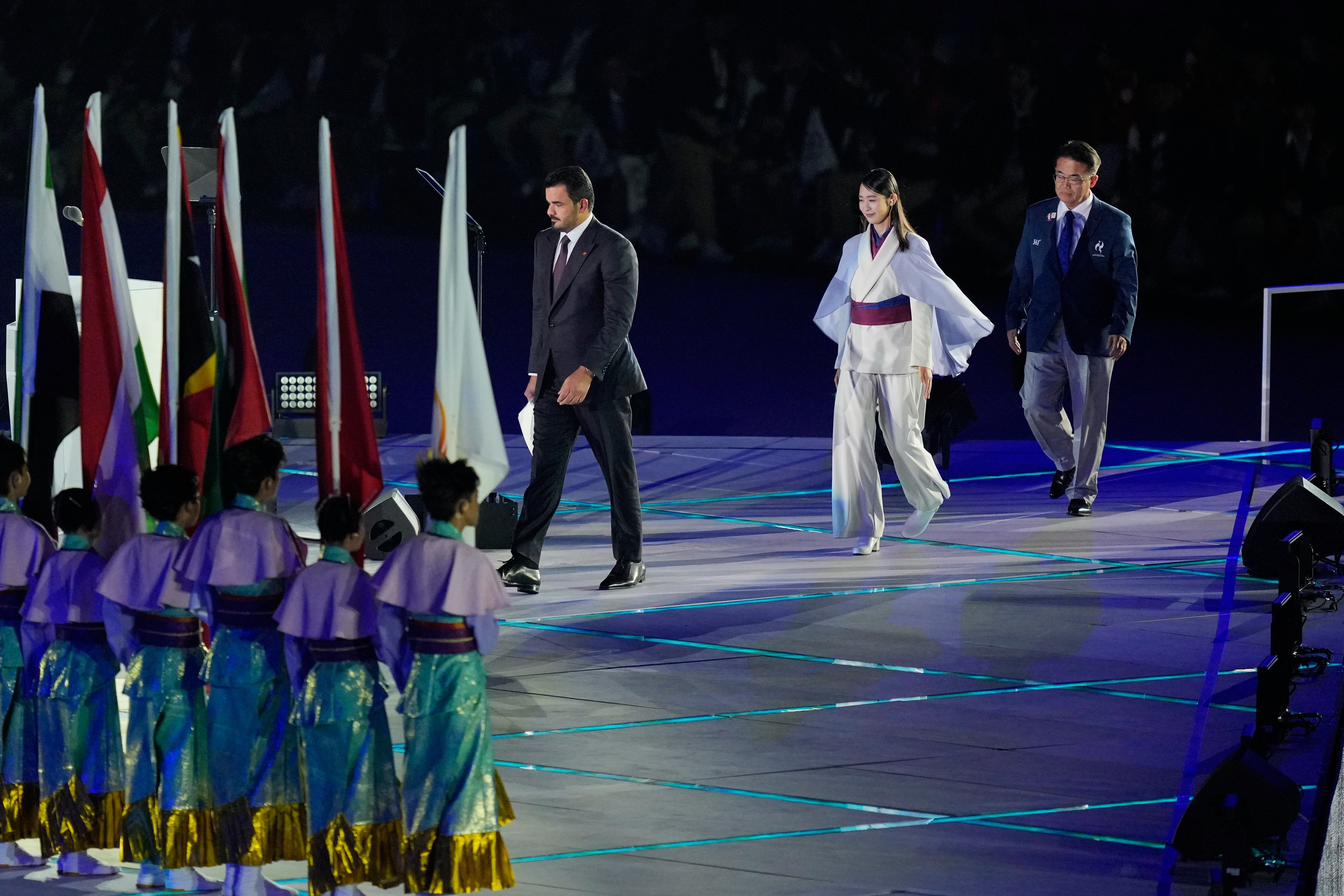Sheikh Joaan bin Hamad Al Thani, centre, left, president of the Olympic Council of Asia, and Aichi Gov. Hideaki Ohmura, right, the president of the Aichi-Nagoya Asian Games Organizing Committee, get on stage during the opening ceremony for the Asian Games in Nagoya, Japan, Saturday, 19 September 2026
