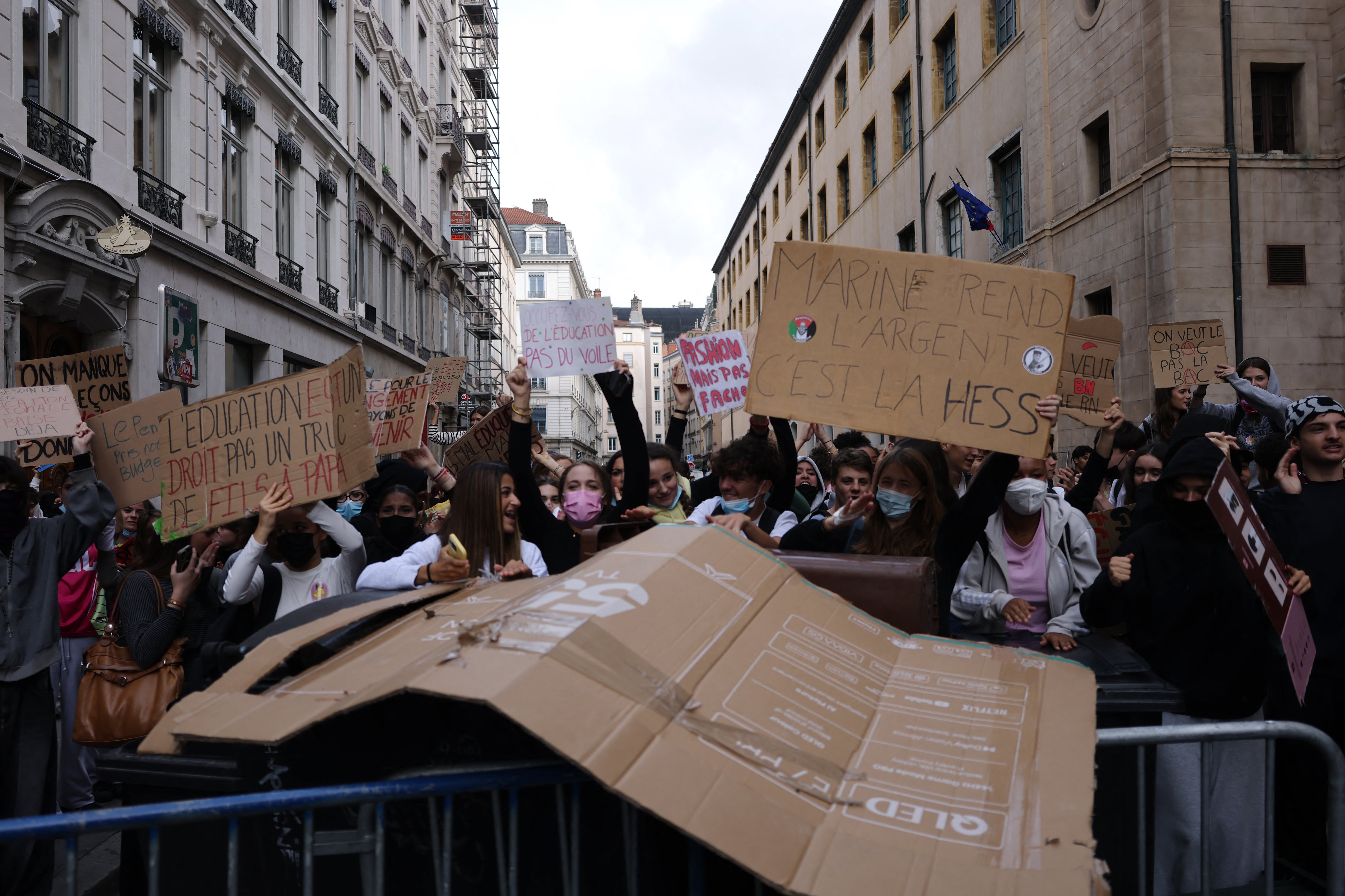 Students hold placards reading “Education is a right, not something for rich kids”  in Lyon (AFP/Getty)