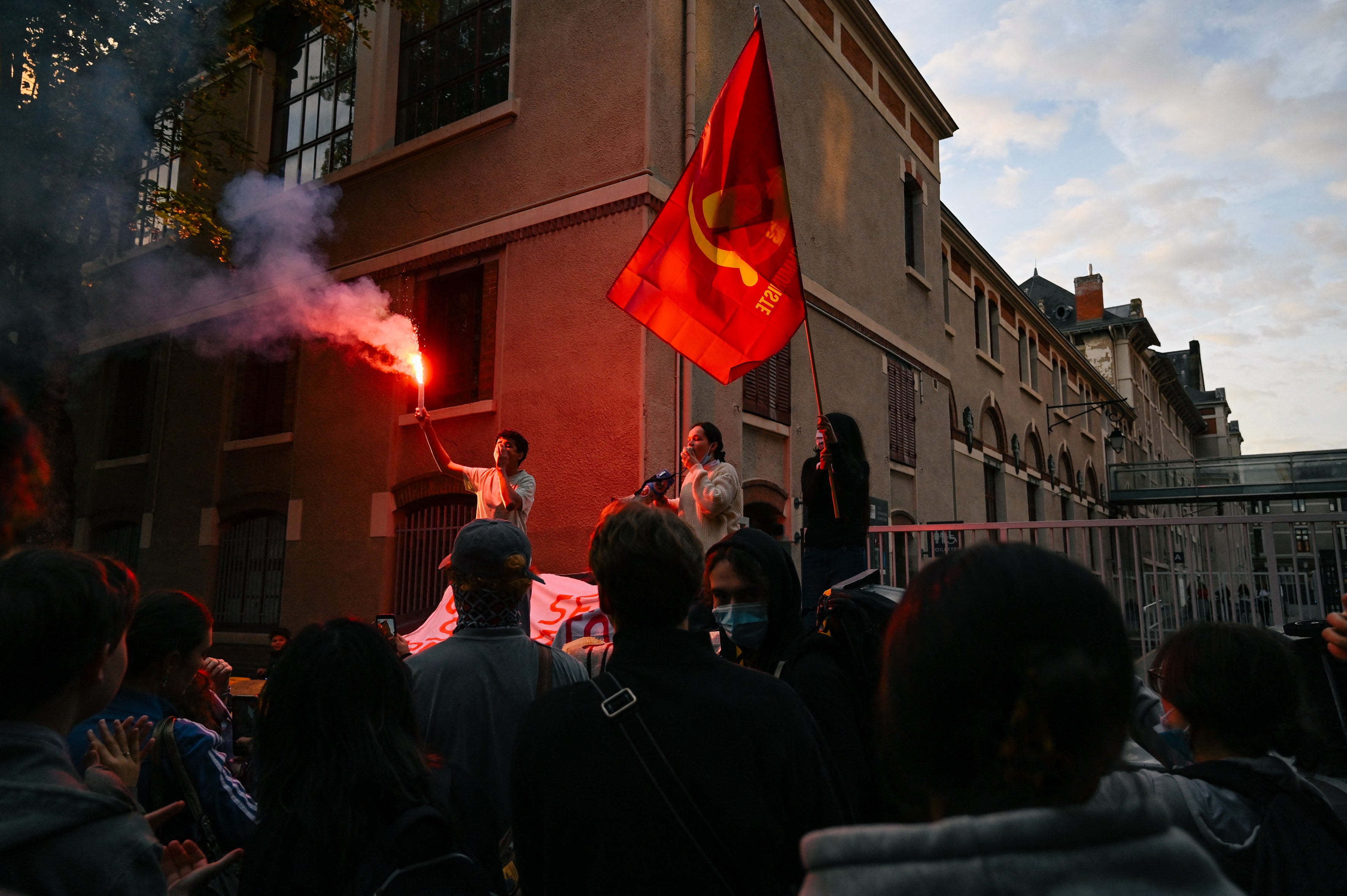 High school students speak on bins and light a smoke torch in front of Jeanne d Arc high school in Clermont-Ferrand (AFP/Getty)