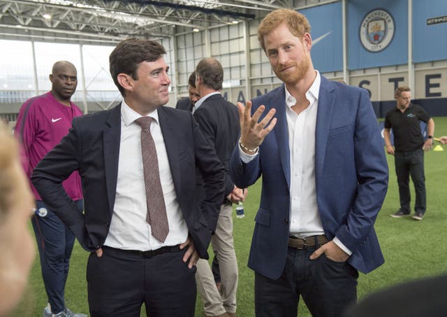 The then Manchester mayor joins Prince Harry at Manchester City's training ground