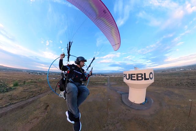 In this image taken from video provided by Jacob Hutzler shows Hutzler flies his paramotor to work as an air traffic controller in Pueblo, Colo., on Aug. 13, 2026. (Jacob Hutzler via AP)