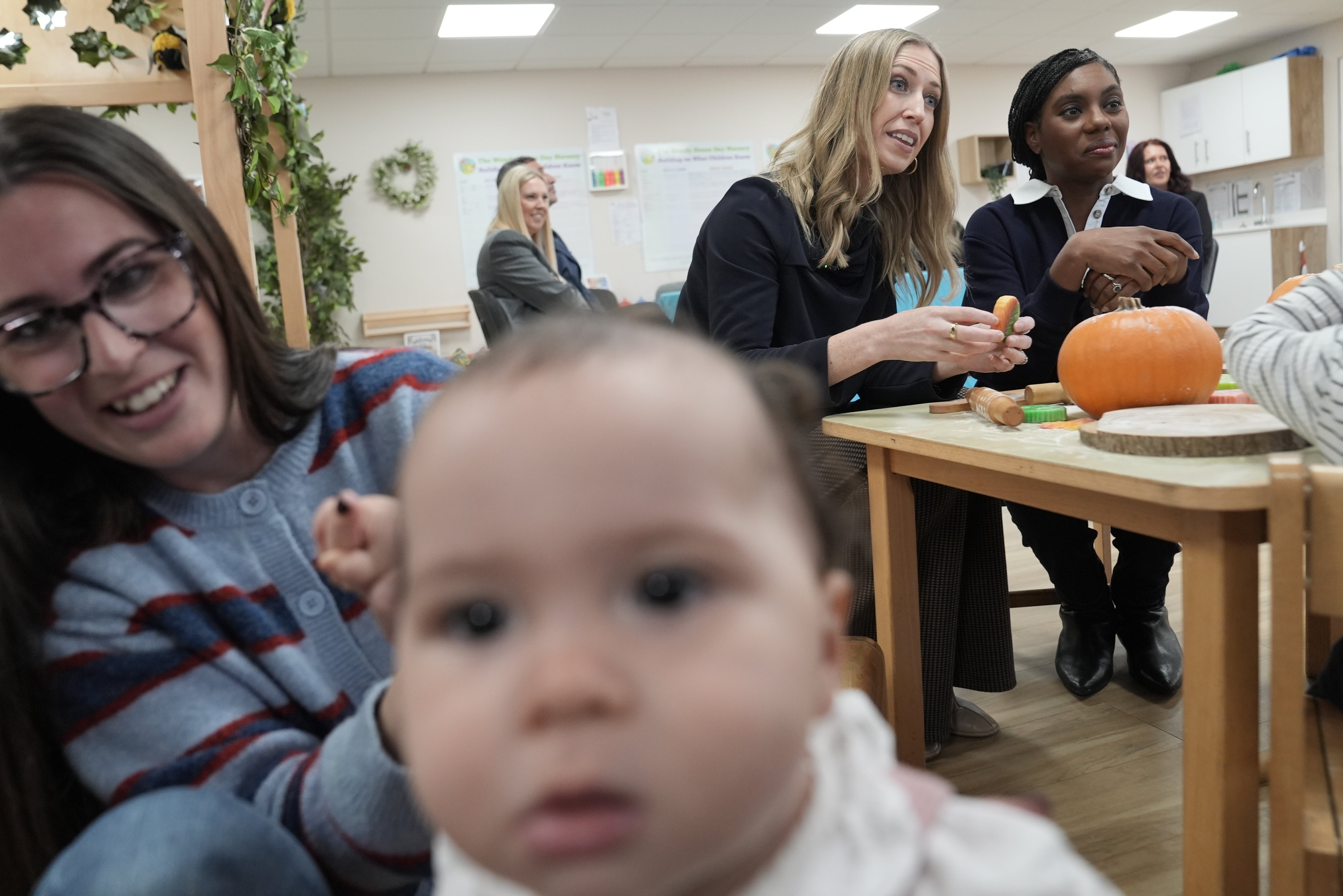 Conservative Party leader Kemi Badenoch (right) and shadow education secretary Laura Trott (centre) during a visit to the Wendy House Day Nursery, in Wythall, Birmingham