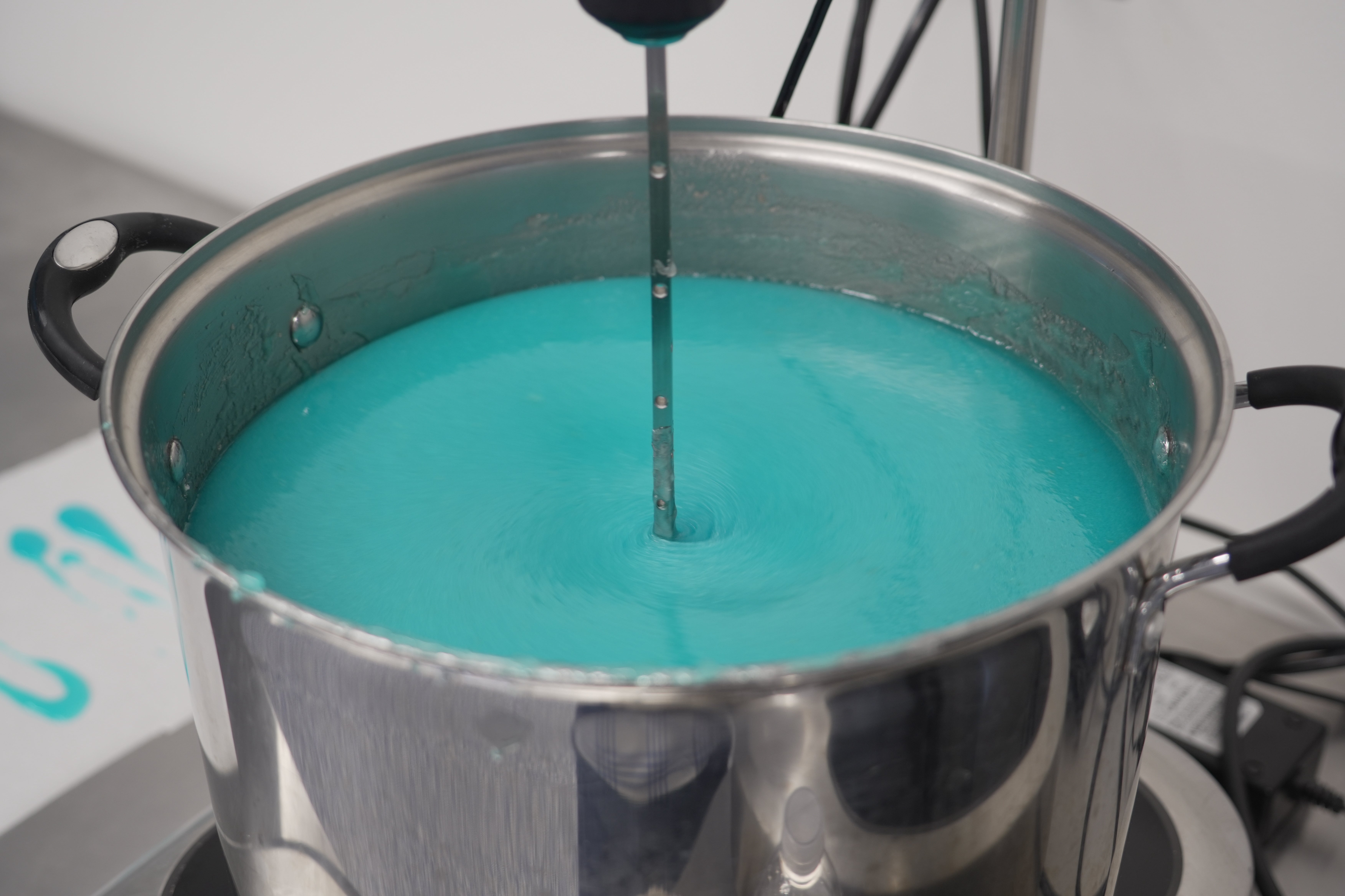 A mixer stirs a batch of blueberry lemonade gummies in a heated pot at the Deutermann Farms kitchen in Clayton, N.C., on Wednesday, Sept. 23, 2026. (AP Photo/Allen G. Breed)