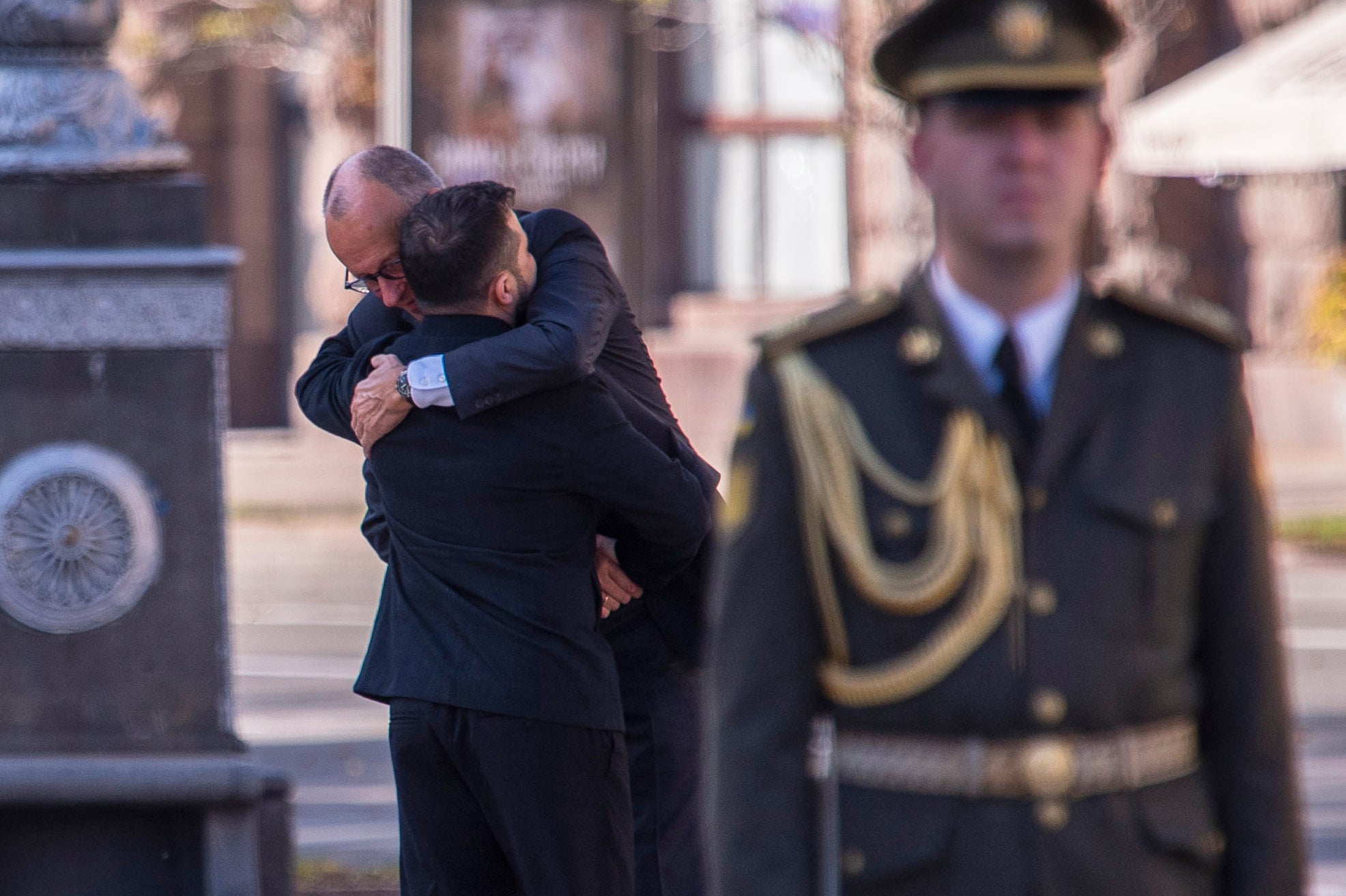 Zelensky and Merz embrace before a commemorative ceremony at the memorial of fallen Ukrainian soldiers at Independence Square in Kyiv