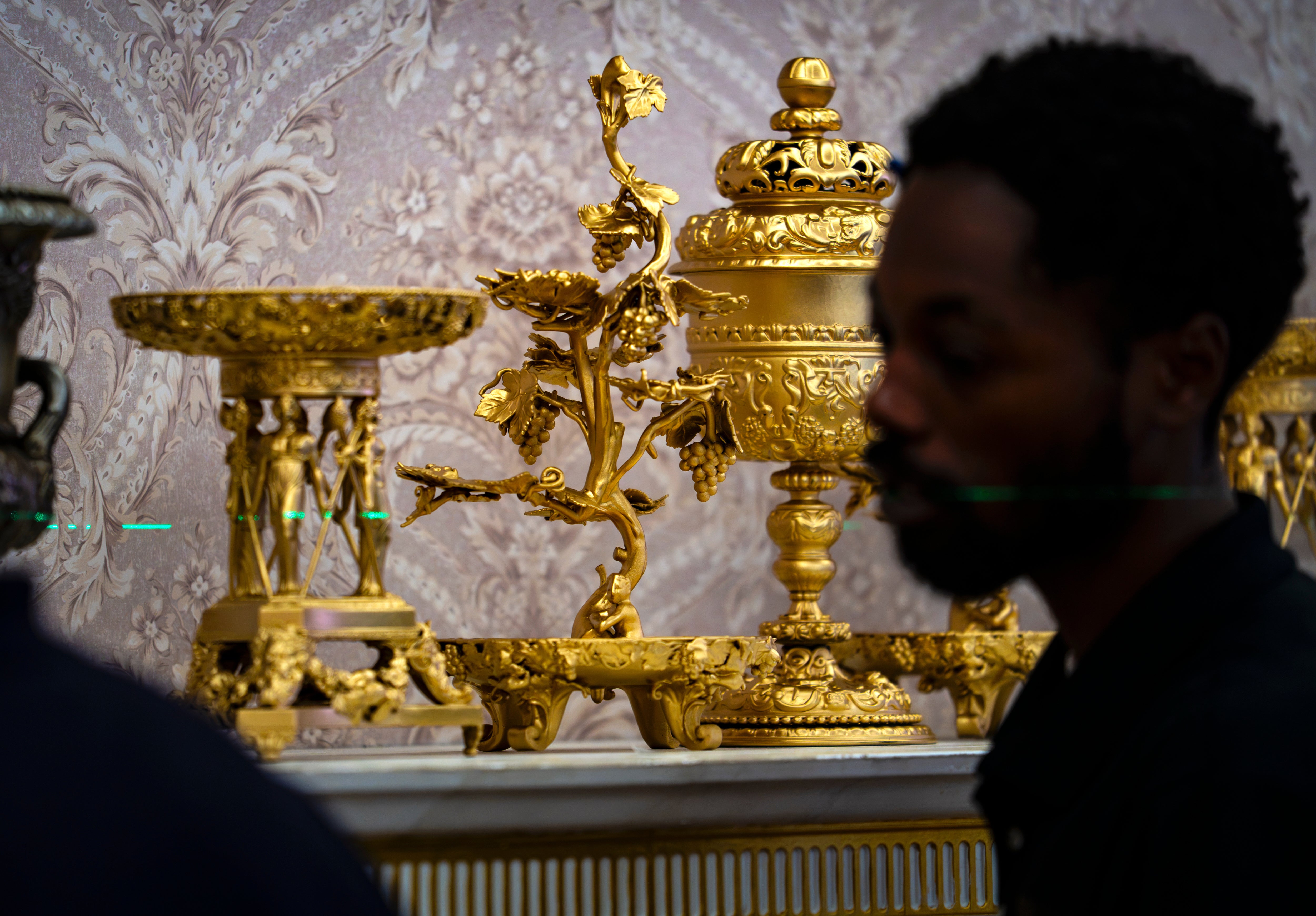 A replica of President Donald Trump's Oval Office is updated to the current decor by workers at "The People's House: A White House Experience," in Washington, Friday, Oct. 2, 2026. (AP Photo/J. Scott Applewhite)