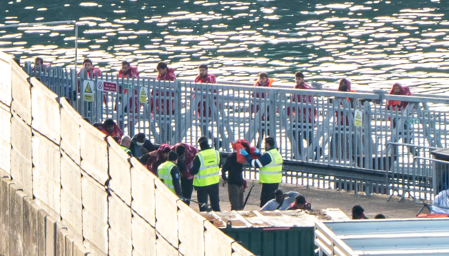 A group of people thought to be migrants are brought in to the Border Security Command compound in Dover, Kent, from a Border Security Command vessel following a small boat incident in the Channel. Picture date: Sunday October 4, 2026.