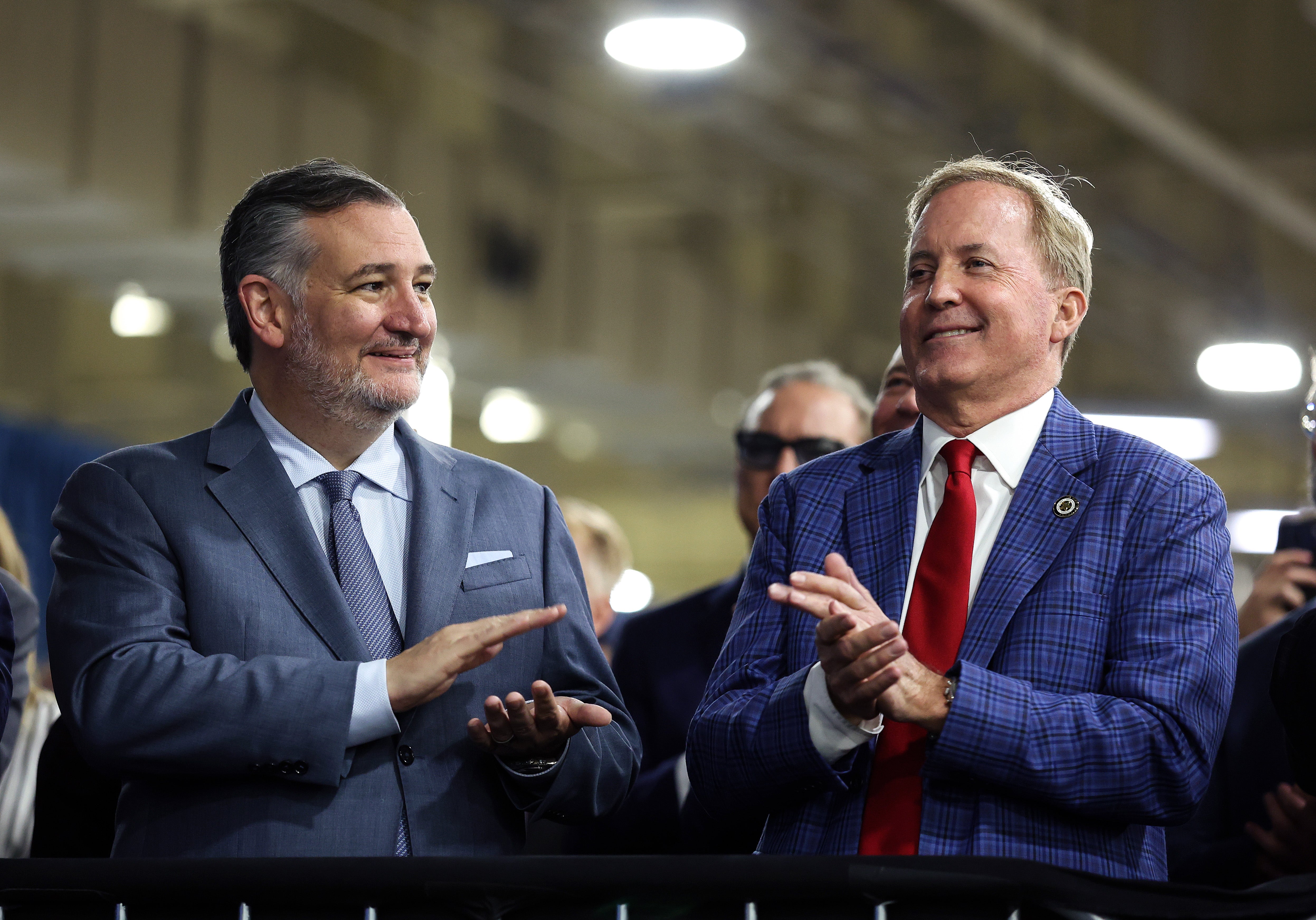Sen. Ted Cruz (R-Texas) (L) and Republican Senate candidate Texas Attorney General Ken Paxton (R) watch as U.S. President Donald Trump speaks during a visit to the Peterbilt Motors truck plant on October 01, 2026, in Denton, Texas.
