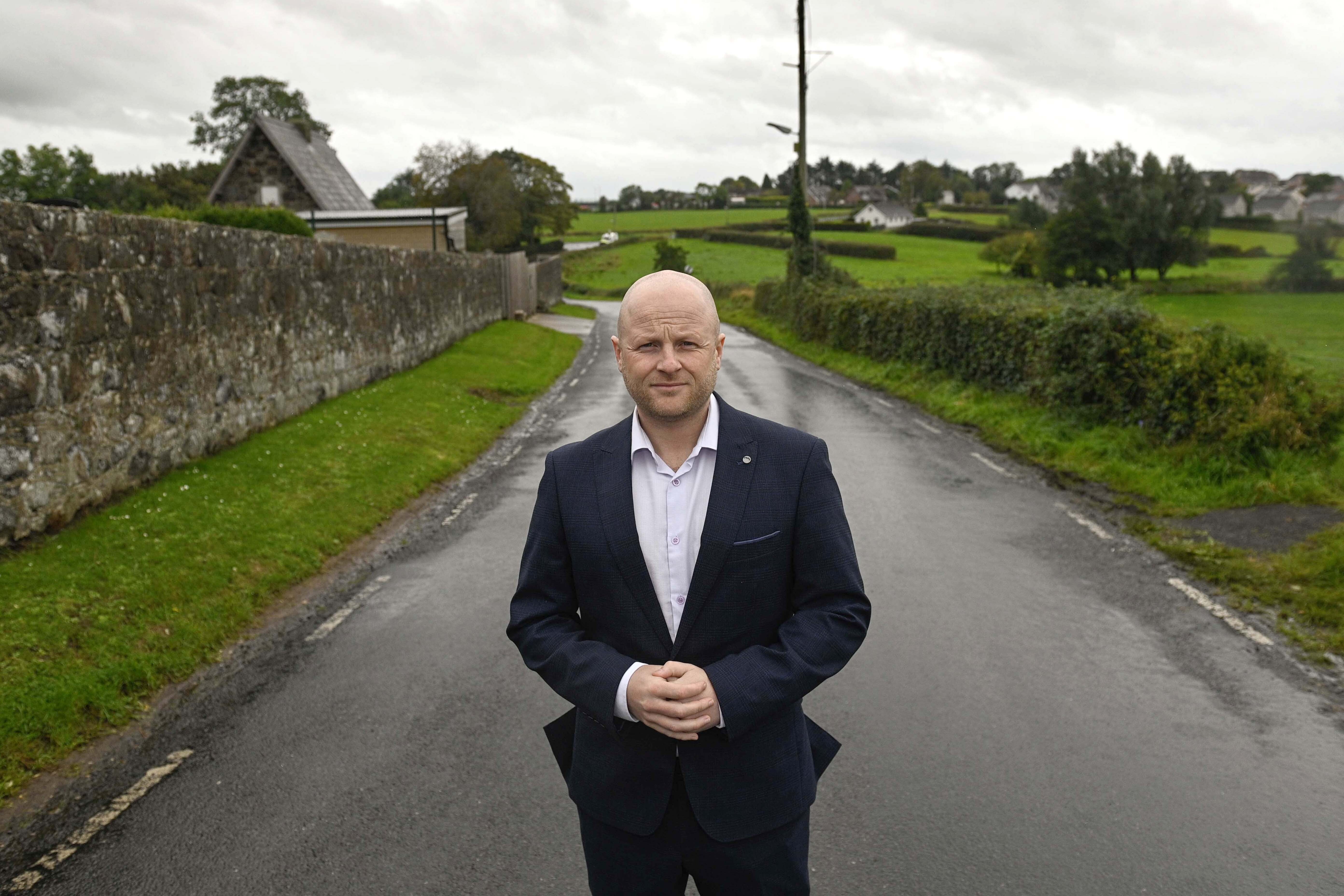 Jamie Bryson stands on The Drumcree Road (Mark Marlow/PA) (PA Wire)