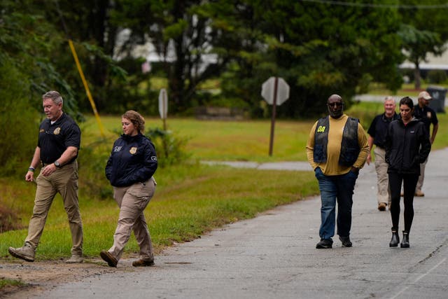 Authorities investigate the scene of a mass shooting where at least two people died and 35 were injured when struck by bullets Sunday morning, according to the Georgia Bureau of Investigation, Sunday, Oct. 4, 2026, in Vienna, Ga. (AP Photo/Mike Stewart)