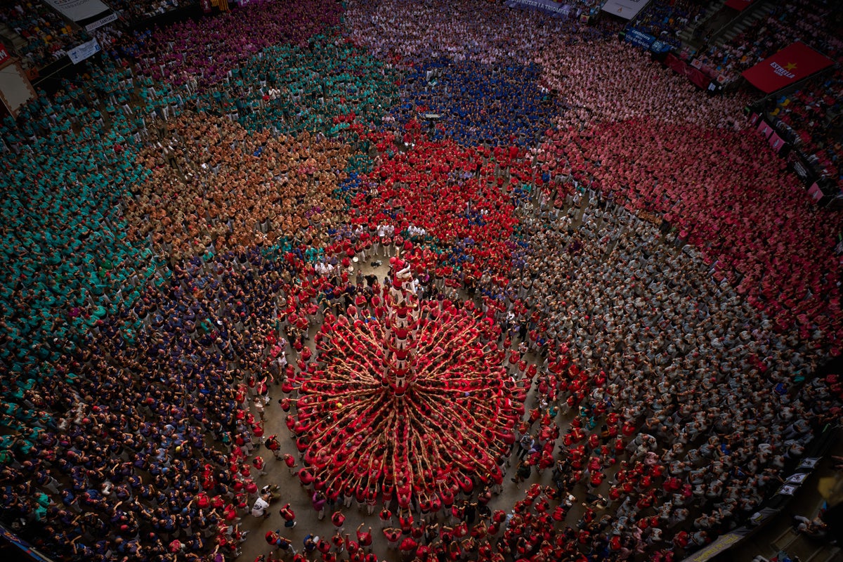 Photos show colorful teams building human towers in Spain’s Catalonia