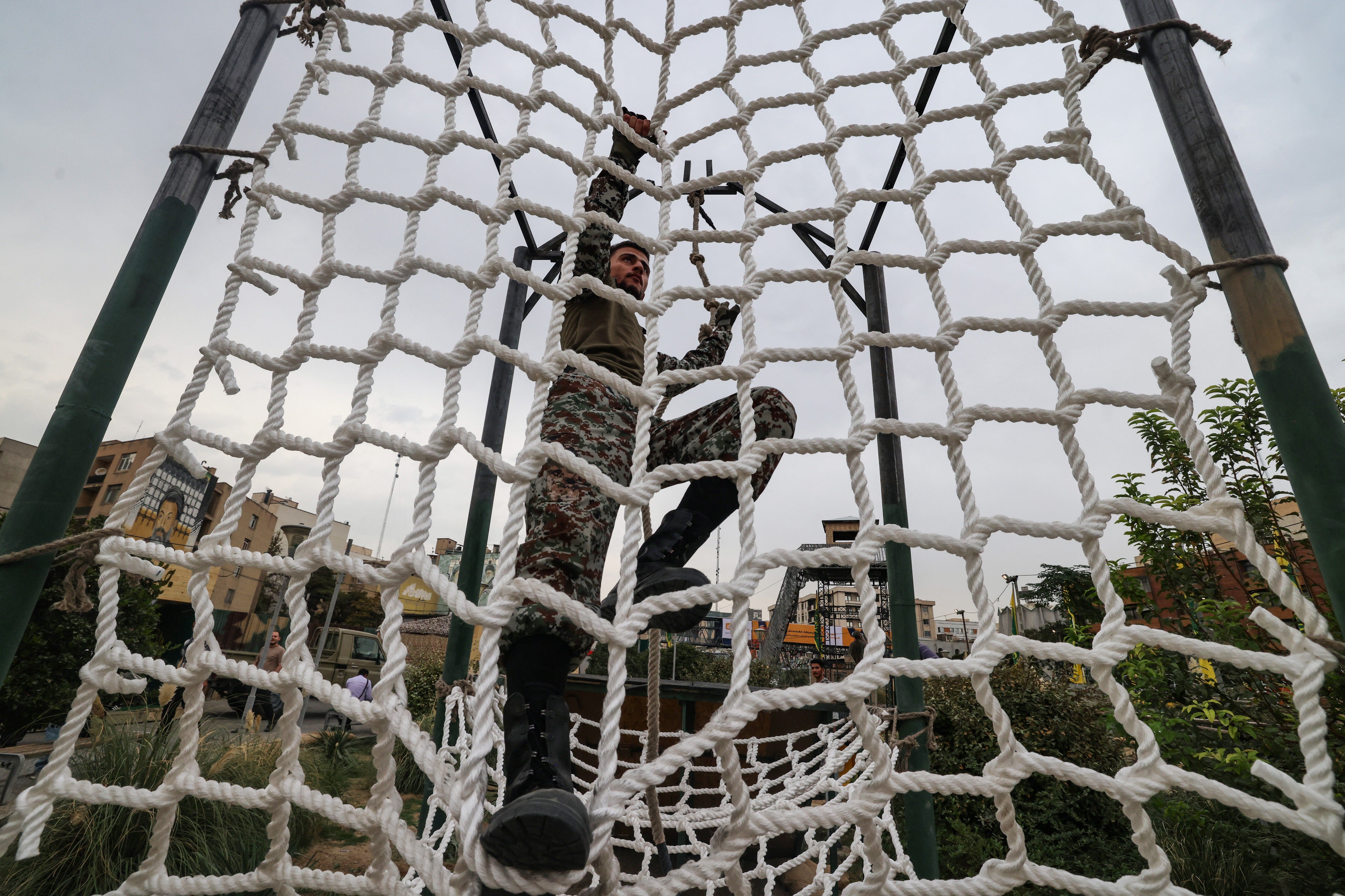 An Iranian man demonstrates an obstacle course during the inauguration of a training centre by the Iranian army in Tehran