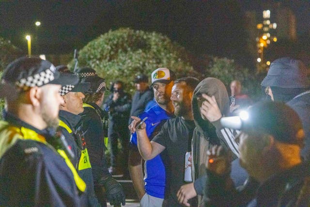 Police and demonstrators during an anti-migrant protest in Gosport