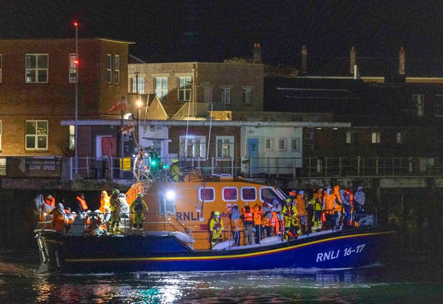 A group of people thought to be migrants are brought in to a marina in Gosport