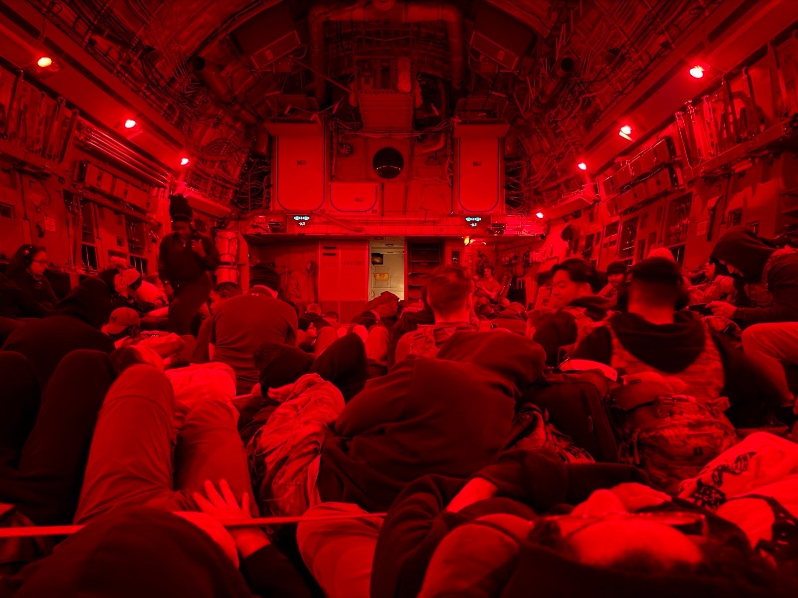 Soldiers, including those injured after an Iranian drone strike on Port Shuaiba, sit inside a military transport plane as they are evacuated from Kuwait