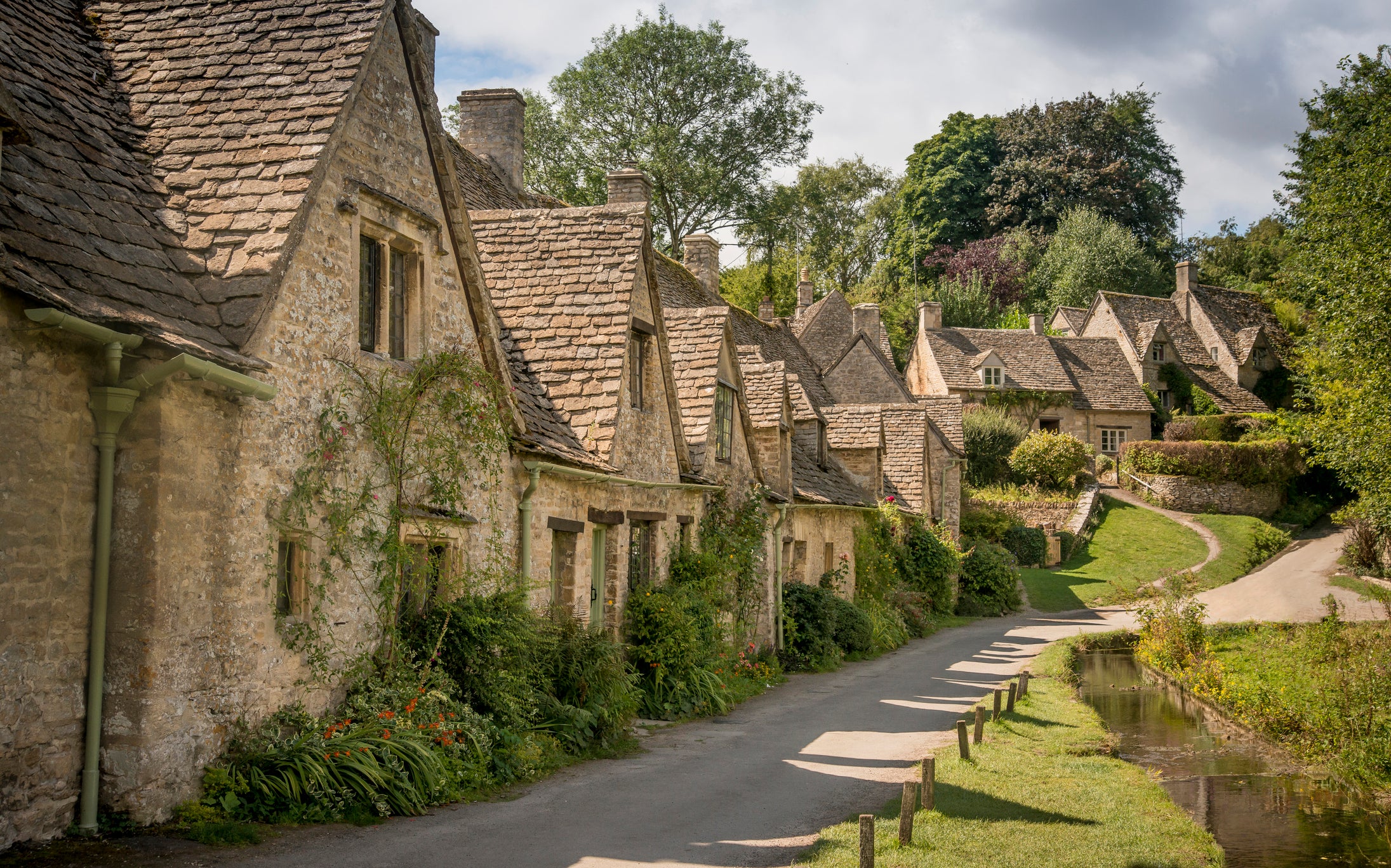 The famous line of cottages at Arlington Row in Bibury were restored and are owned by the National Trust