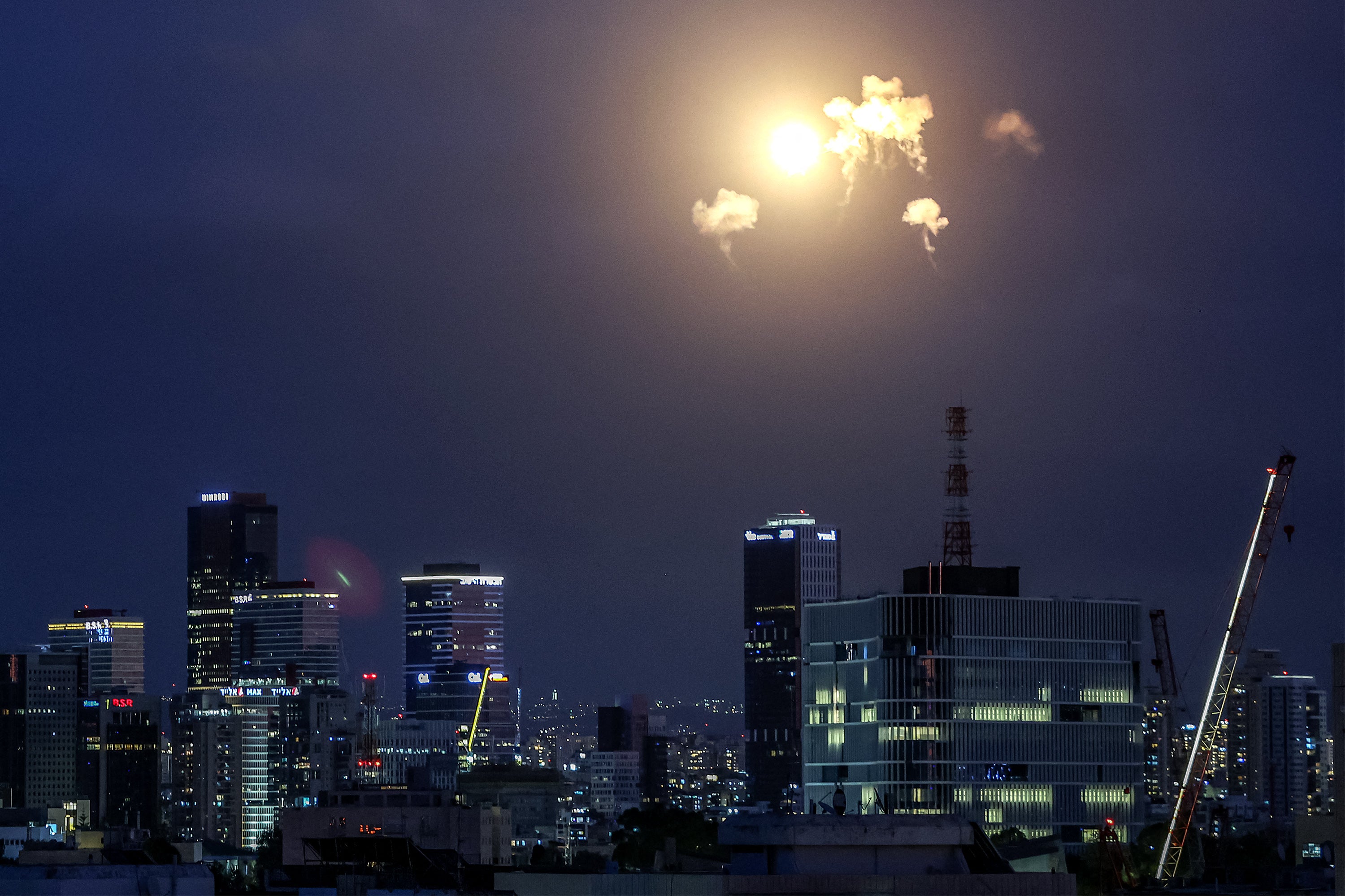 Explosions from projectile interceptions by Israel's Iron Dome missile defence system are pictured over Tel Aviv on February 28