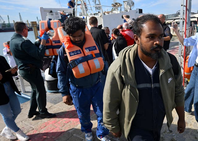 Crew members from a ship damaged in a drone attack disembark from a Bulgarian border police vessel in Varna, Bulgaria, following a rescue operation after one vessel was sunk and another damaged in the Black Sea off Bulgaria