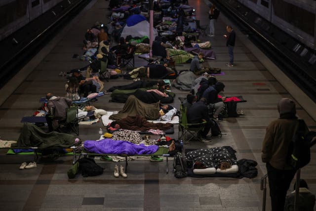 People take shelter inside a metro station during a Russian missile strike, amid Russia's attack on Ukraine, in Kyiv