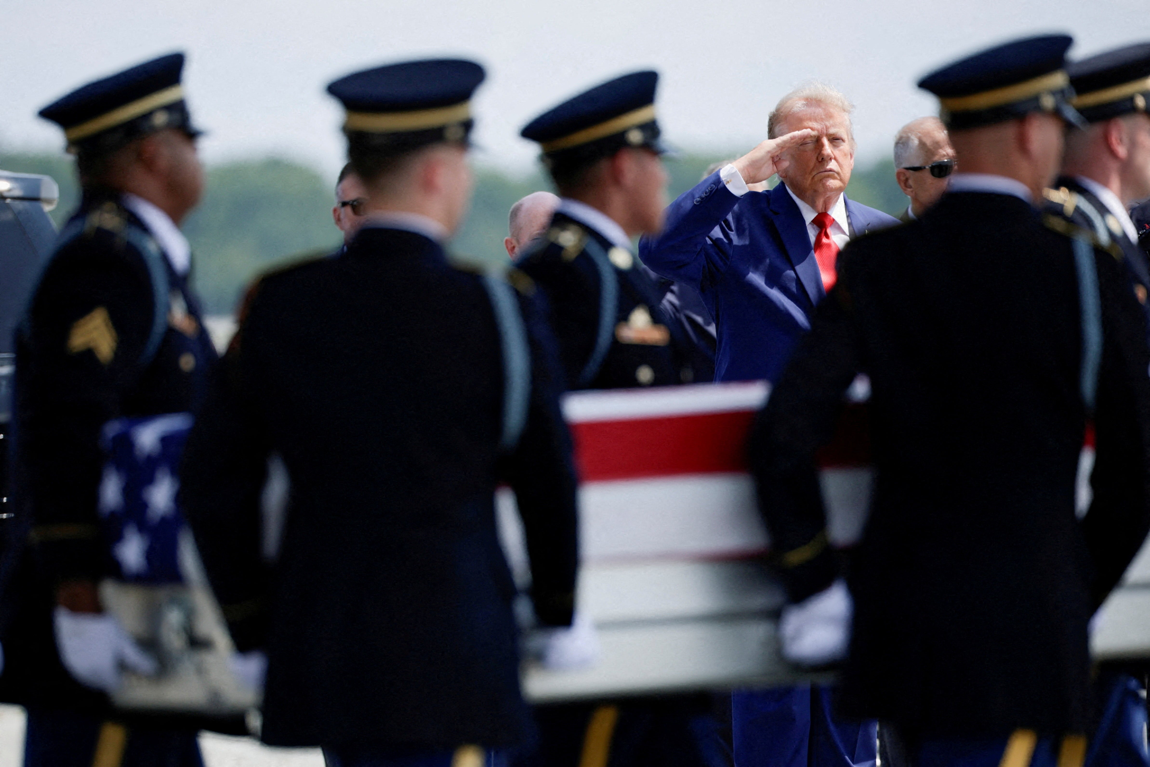 President Donald Trump salutes as members of the military carry the transfer case of U.S. Army Sgt. Angel S. Rampersad of the 1st Battalion, 57th Air Defense Artillery Regiment, 52nd Air Defense Artillery Brigade, 10th Army Air Missile Defense Command, who was killed during an attack at Muwaffaq Salti Air Base in Jordan