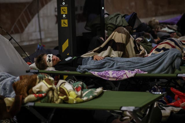 Residents sleep as they take shelter inside a metro station during a Russian missile strike, amid Russia's attack on Ukraine, in Kyiv