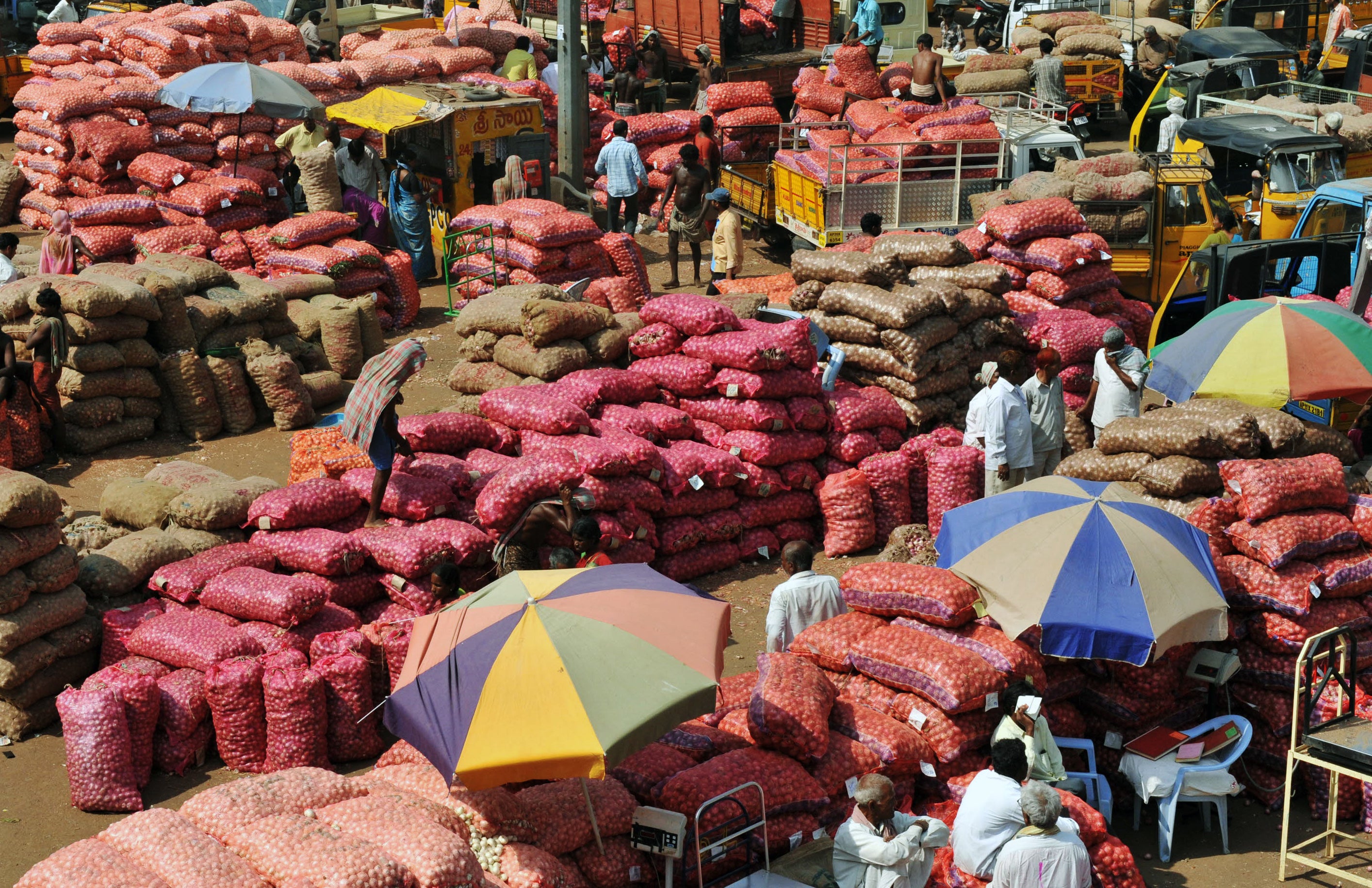 Indian farmers and traders dealing onions at a wholesale market in Hyderabad