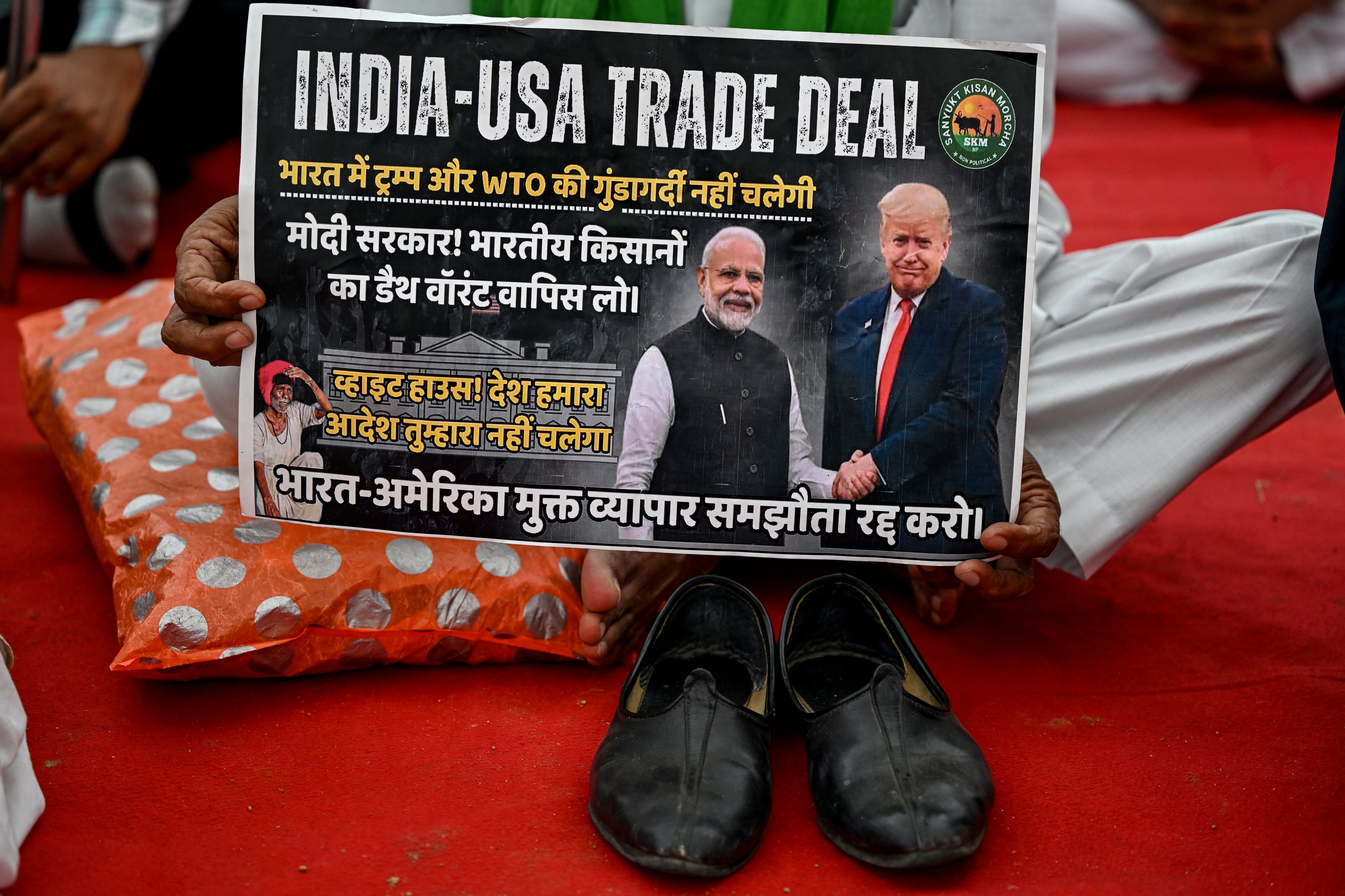 A farmer takes part in a protest demanding a legal guarantee of minimum support price for crops and the exclusion of agricultural imports from the India-US free trade agreement