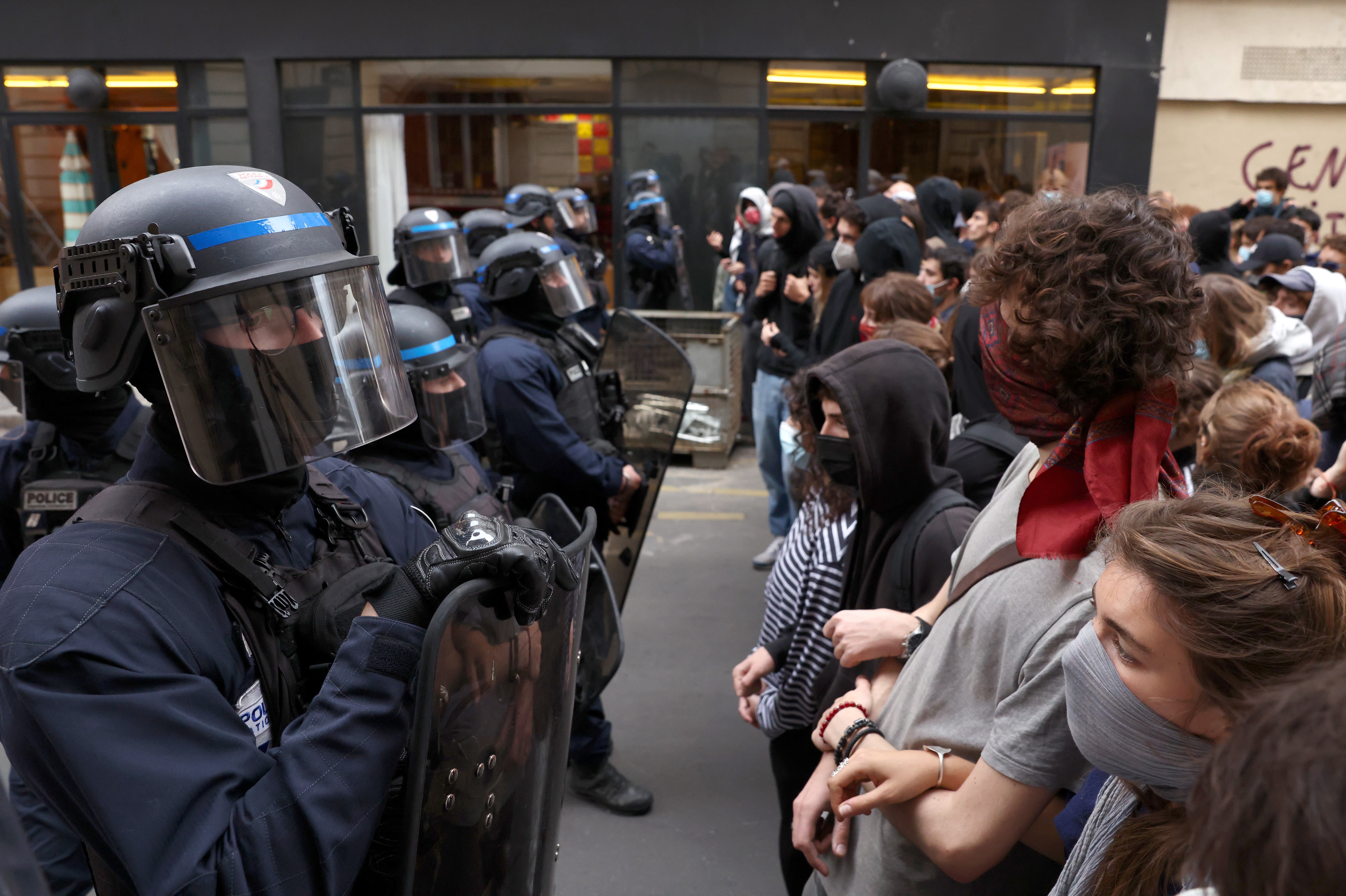 Police watch over students as they demonstrate during a protest over school overcrowding and decay on 7 October in Paris, France