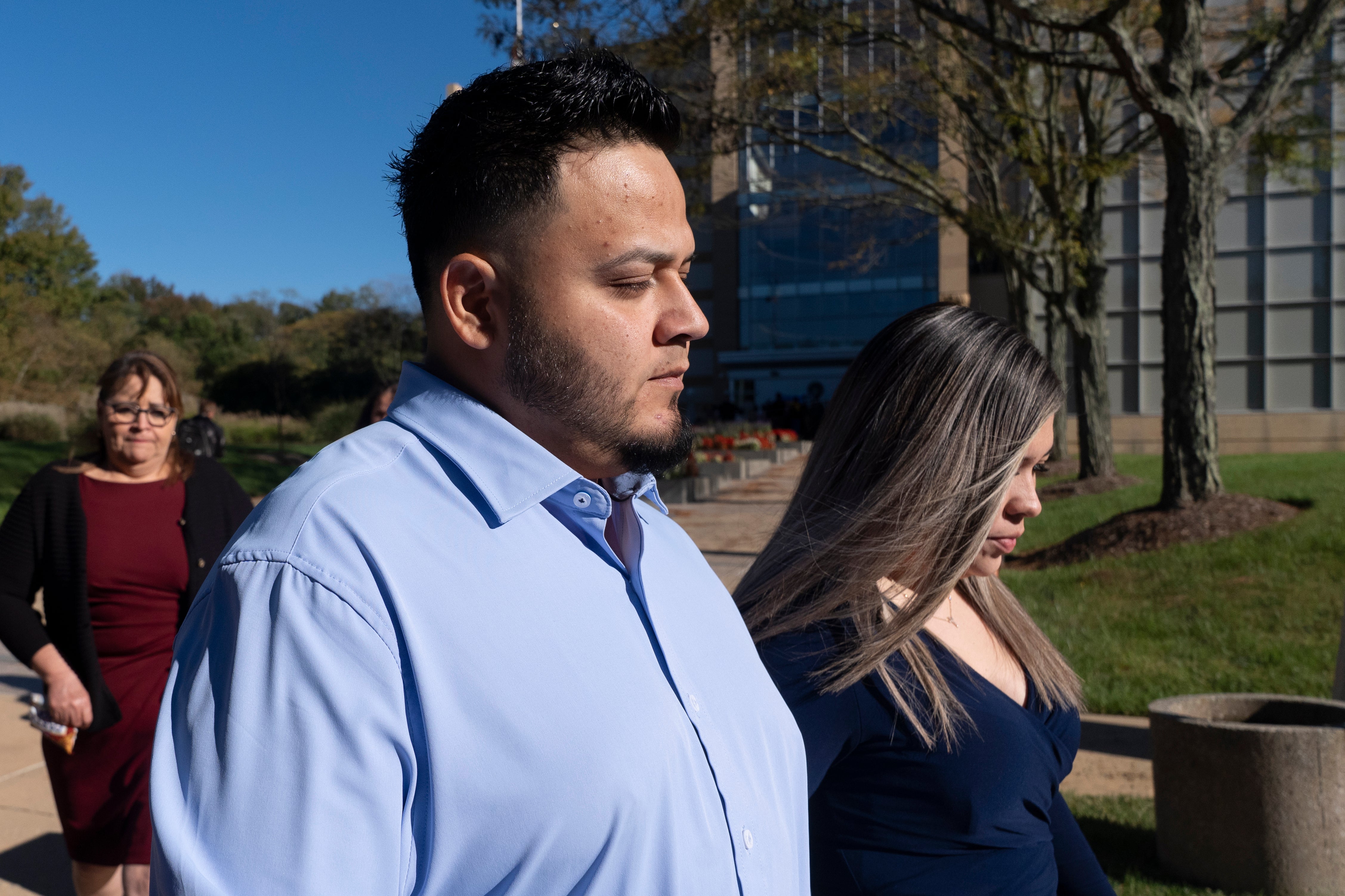 Kilmar Abrego Garcia and his wife Jennifer Vasquez Sura, right, leave the U.S. District Court for the District of Maryland, in Greenbelt