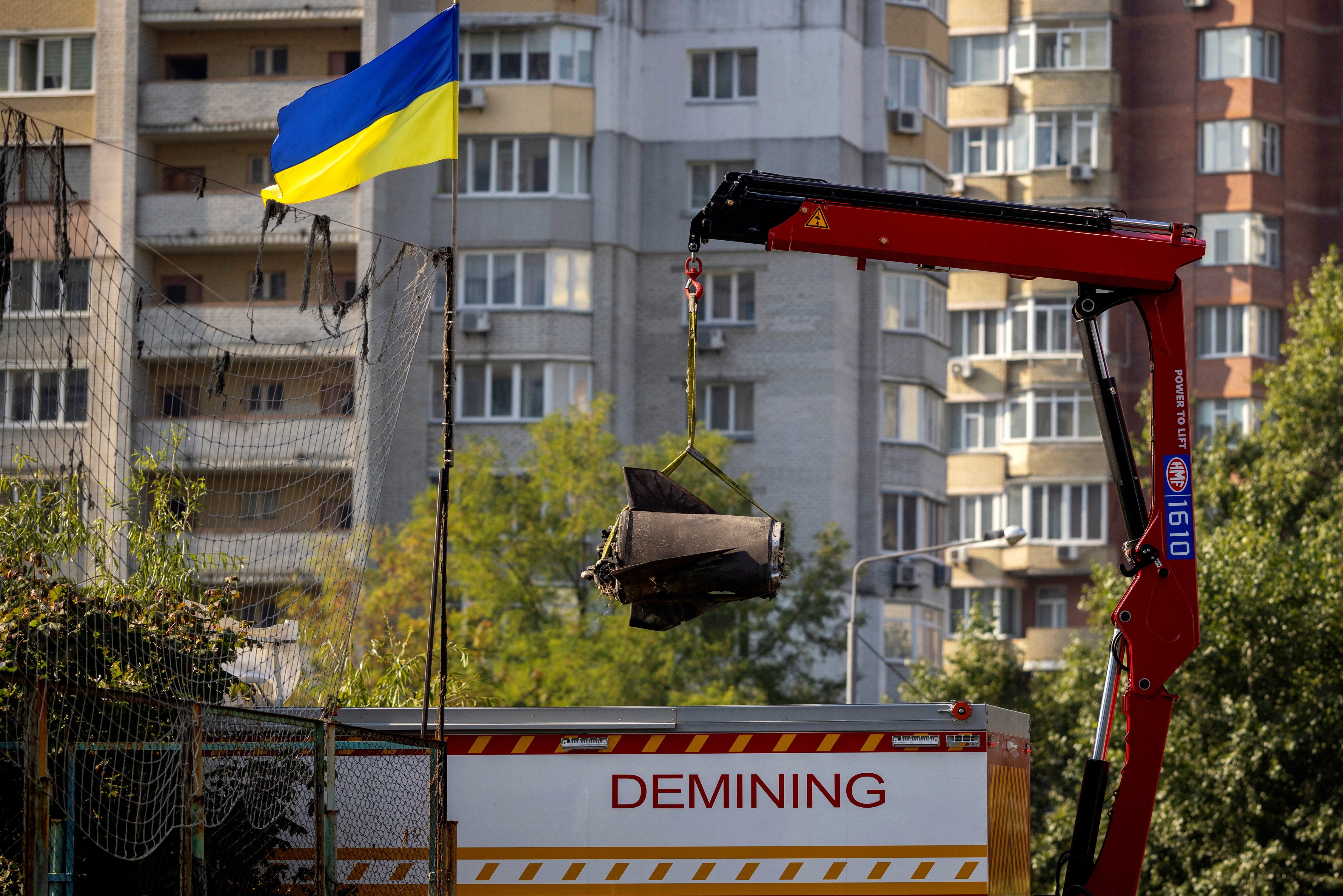 EOD specialists remove the debris of a Russian missile that fell in a residential neighborhood during a night of Russian missile attacks