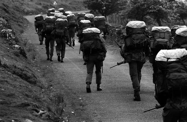 SAS recruits trek to the top of a mountain peak with 45lb backpacks on as part of an endurance exercise in the 1980s
