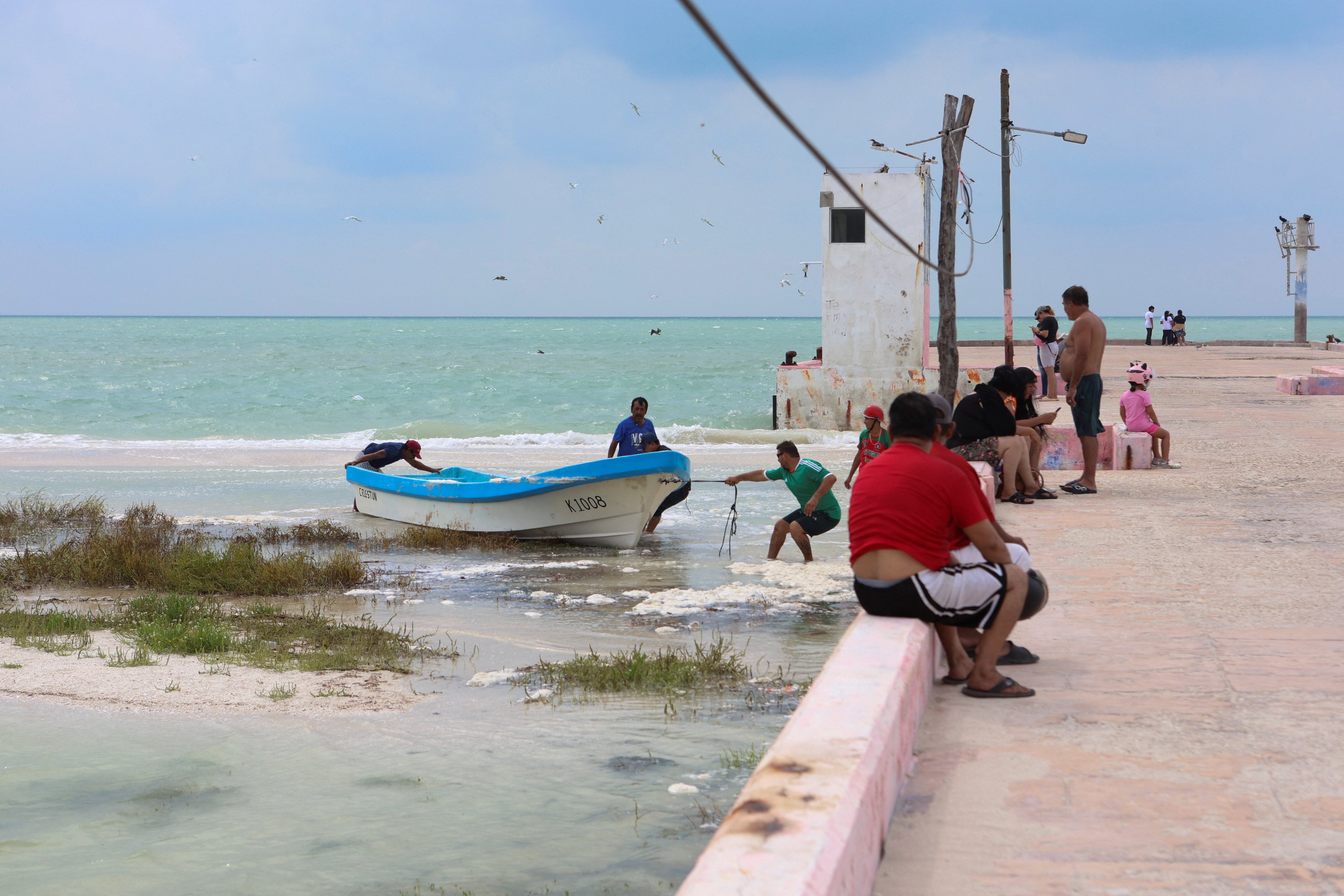 Fishermen secure their boats as Tropical Storm Isaias moves through the Gulf of Mexico