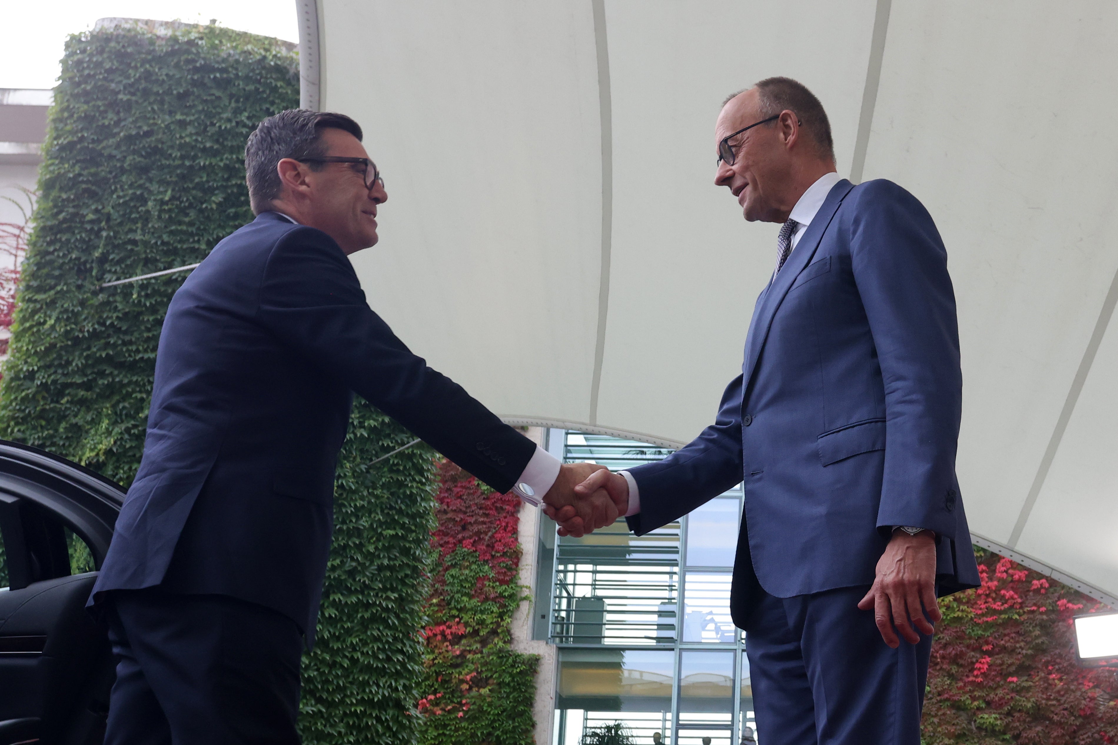 German Chancellor Friedrich Merz (R) welcomes British Prime Minister Andy Burnham