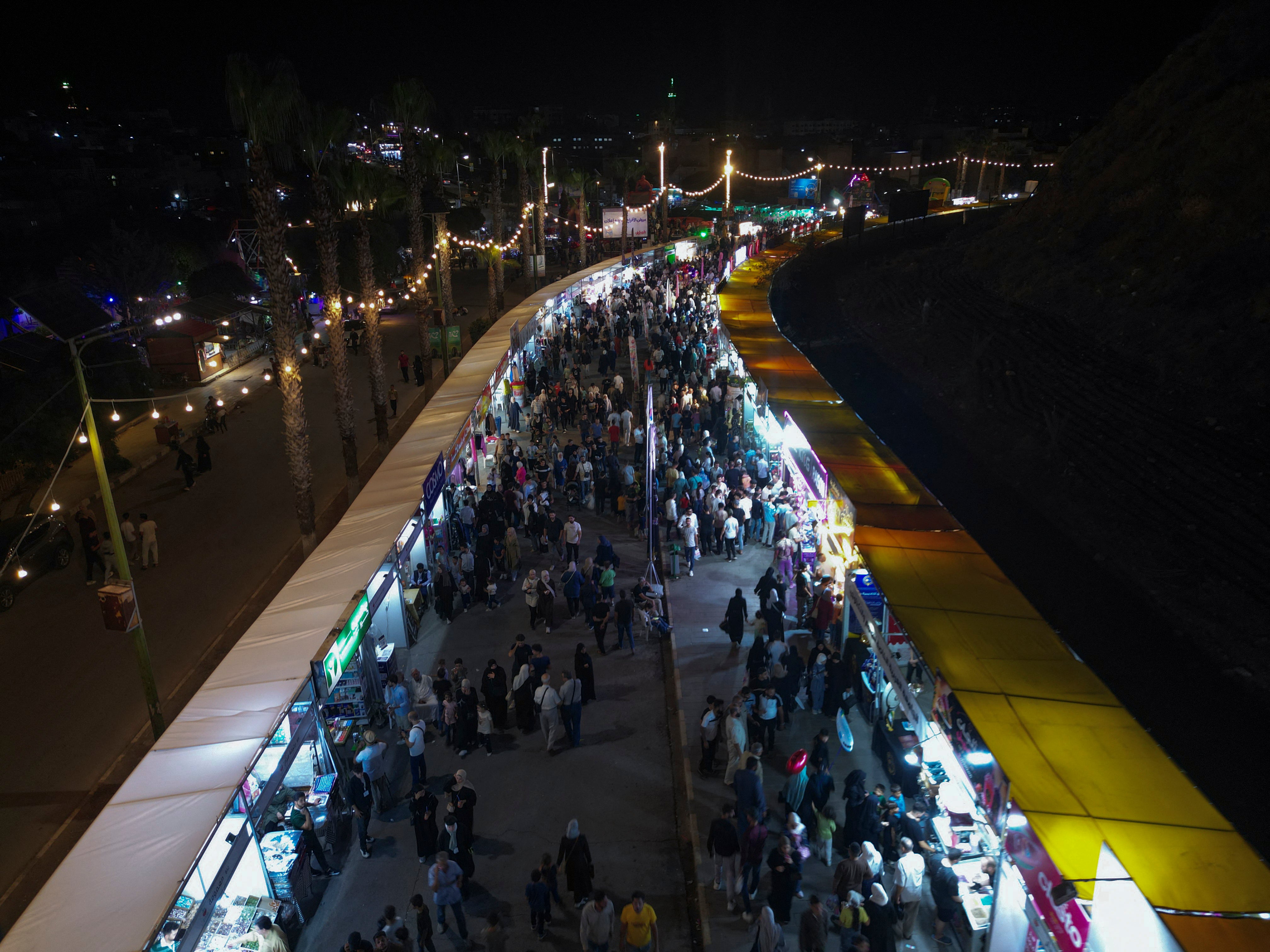 An aerial view shows crowds moving through exhibition areas at the Hama Spring Festival in Hama, Syria on September 7, 2026