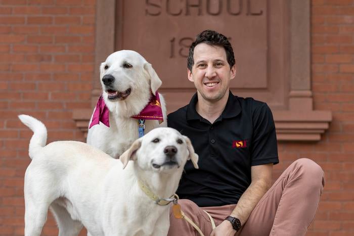 Noah Snyder-Mackler with his two dogs Homer, center, and Juno