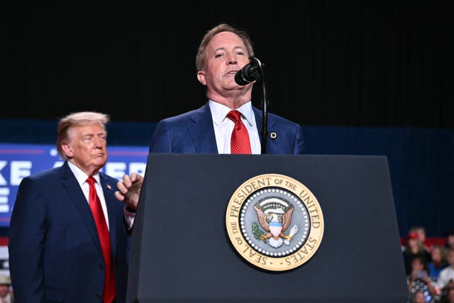 Trump listens as Republican candidate for Senate Ken Paxton speaks at a campaign rally at the Freeman Coliseum in San Antonio, Texas, on October 7 ( AFP via Getty Images )