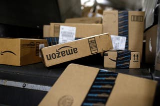 Packages in Amazon boxes move along a conveyor belt at the UPS Worldport hub in Louisville, Ky., Nov. 20, 2015. (AP Photo/Patrick Semansky, File)