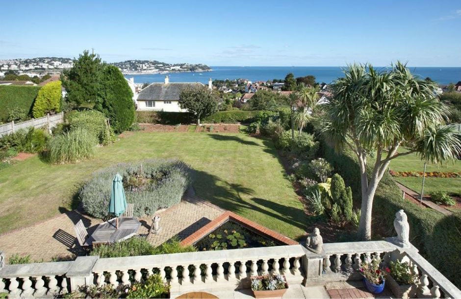 Estate agency boss Sarah Douglas, 57, moved into her £700,000 hilltop house, which boasts far-reaching 'fabulous views' across the sea and coastline of Devon