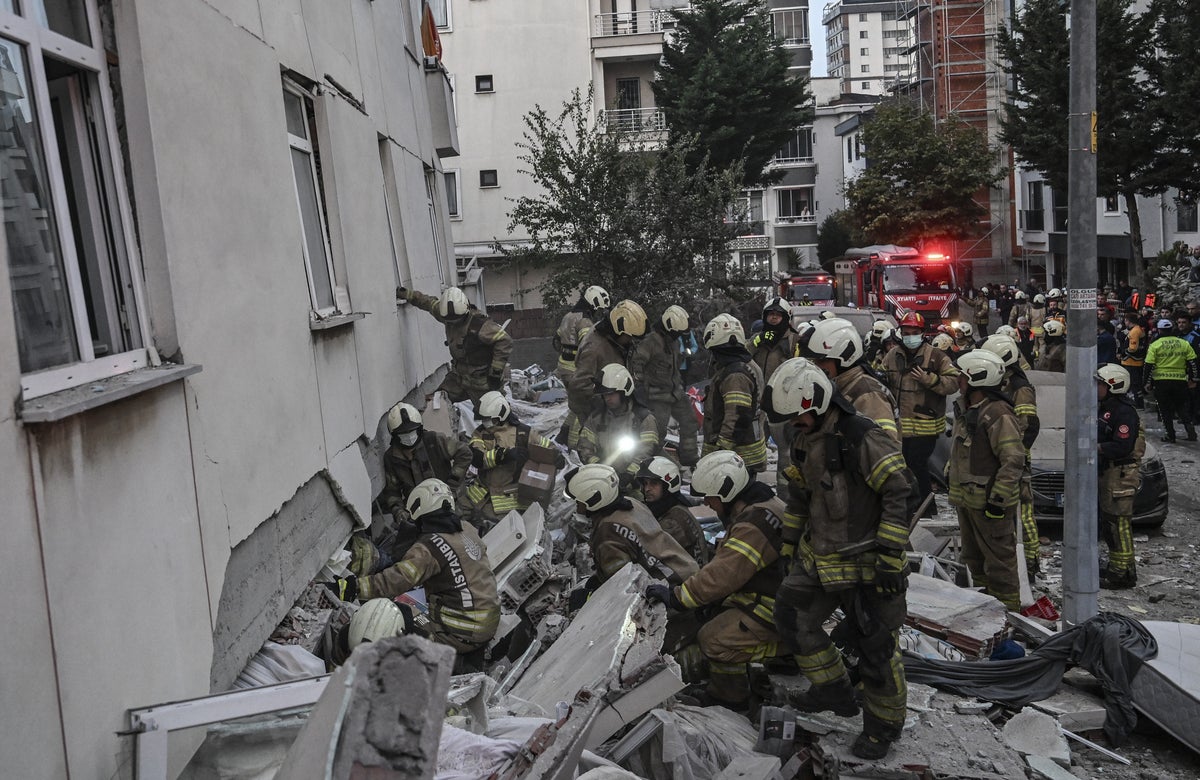 Frantic search for people trapped under rubble after seven-storey flat collapses in Istanbul