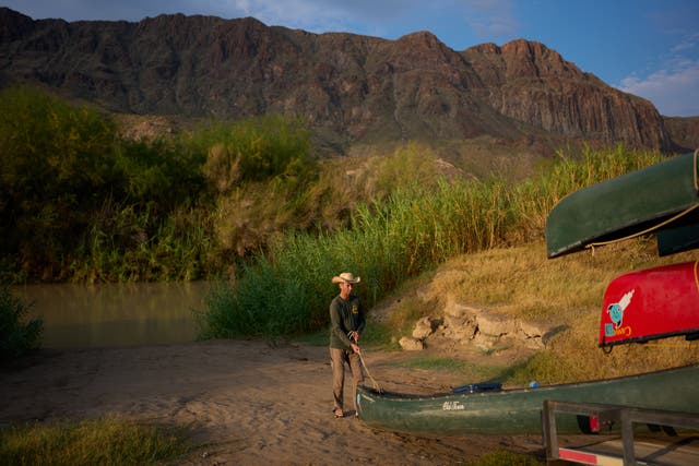 Charlie Angell unloads a canoe during a guiding trip on the Rio Grande river in Big Bend Ranch State Park, Thursday, Sept. 24, 2026, near Redford, Texas. (AP Photo/John Locher)